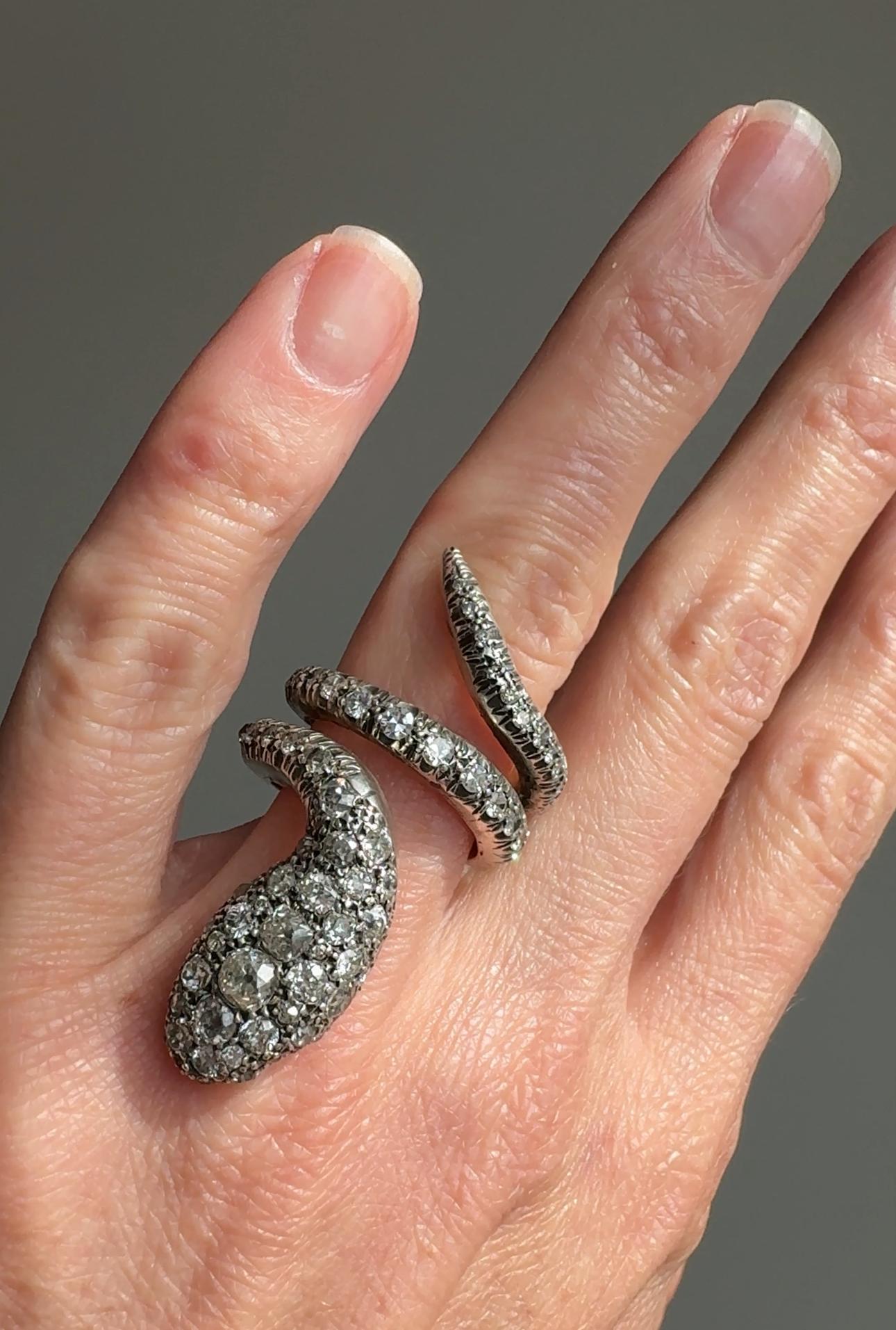 The serpent was a beautiful Victorian era symbol of everlasting love and devotion. This ravishing late Victorian era token of love is truly something special. Circa 1890, this sly diamond encrusted serpent glitters with 4 carats of old mine-cut