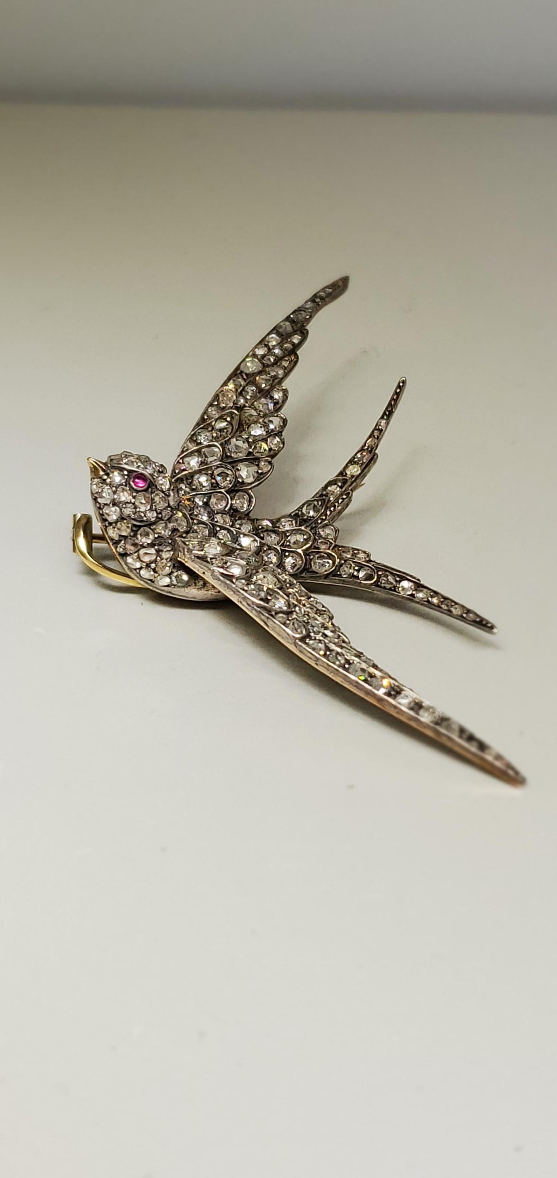 A yellow gold and silver diamond swallow brooch with ruby eye 

Approx 1.78 ct  rose cut diamonds

Silver and Gold