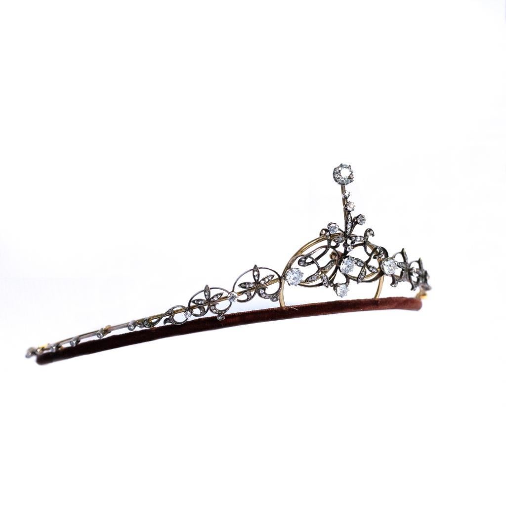 A Victorian diamond set tiara.

This striking handmade Victorian yellow gold and silver diamond tiara is of scrolling floral design set to its centrepiece with four larger old cut diamonds, the largest an impressive 1.80 cts approximately, mounted