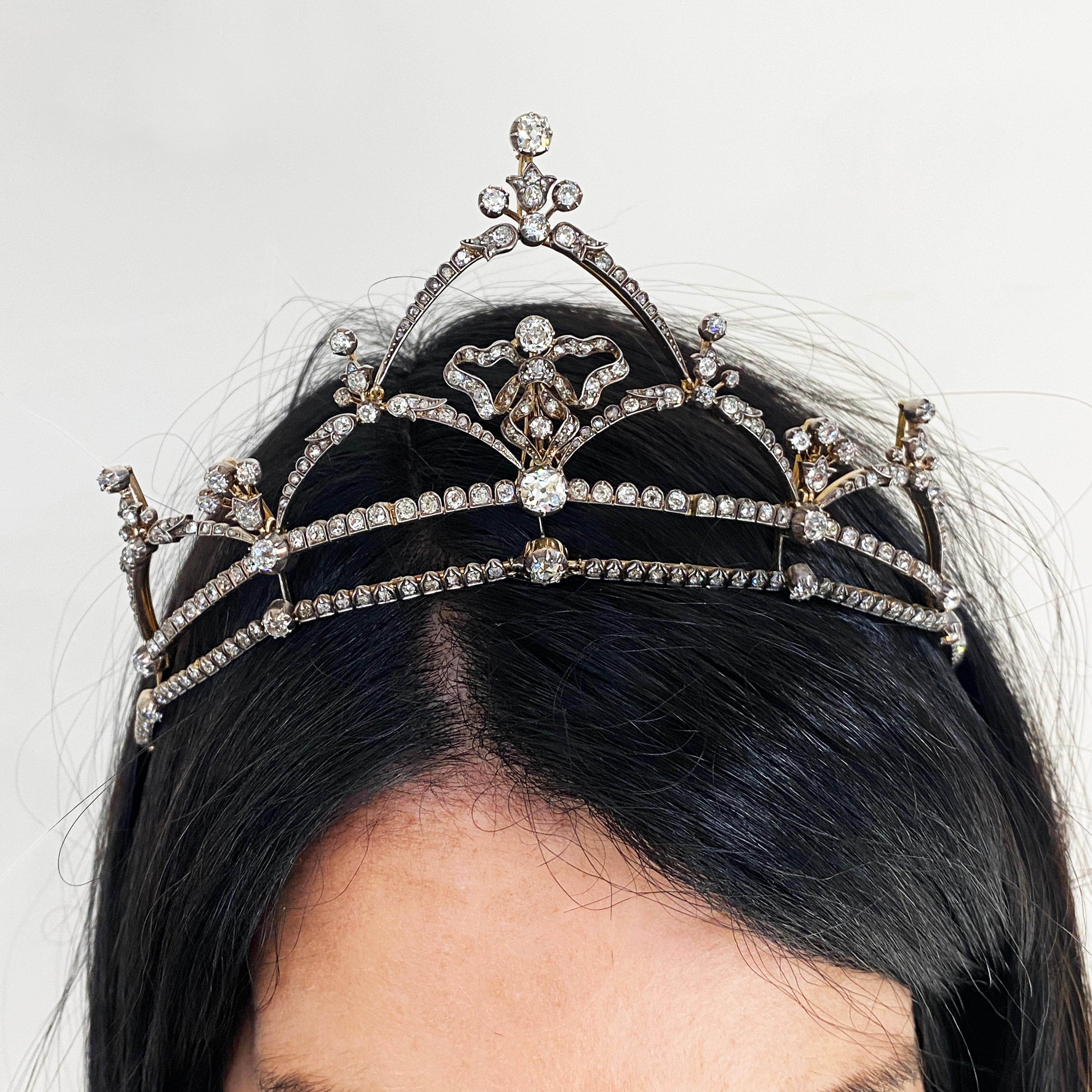 A late Victorian diamond tiara, with the option of converting into a necklace, comprised of an old-cut diamond set fringe swag, with an open bow design, the diamonds set in silver cut-down settings with gold galleries. Set with an estimated total of