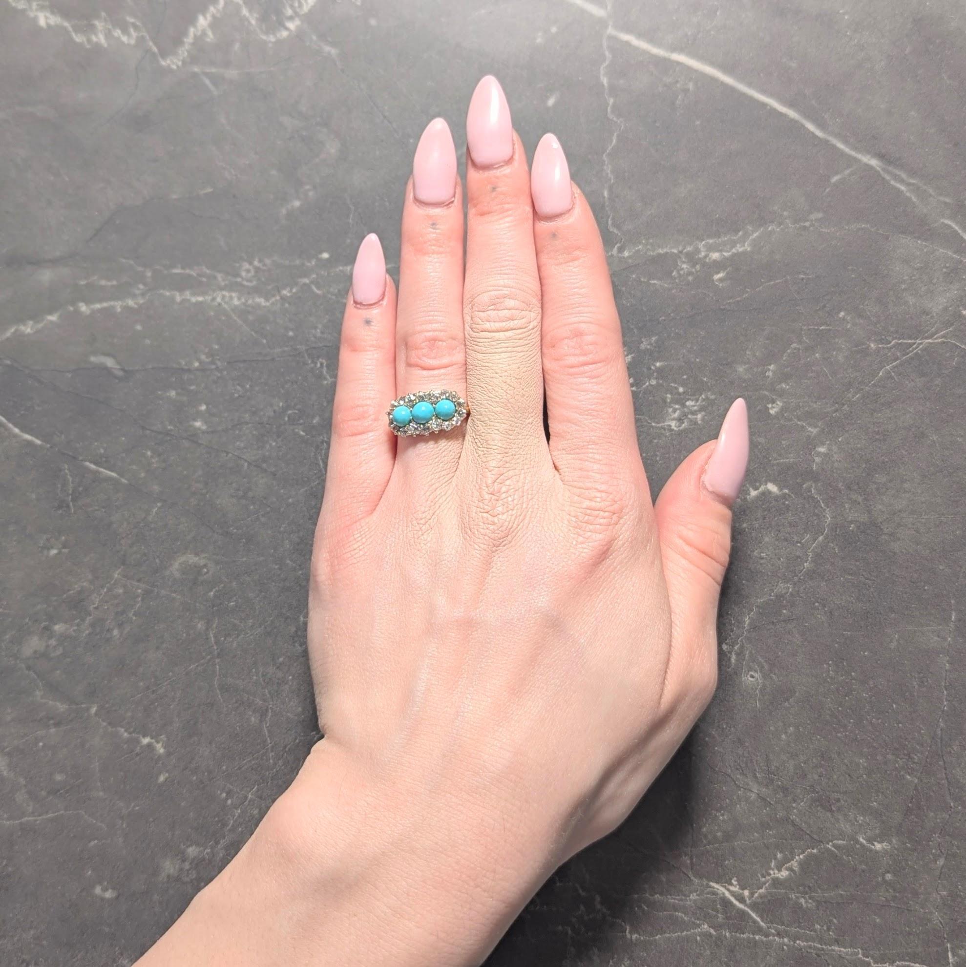 Featuring three round shaped turquoise cabochons flush set east to west
Measuring 5.0 mm round and opaque saturated robin's egg blue in color
Accented by old mine cut diamonds prong set as halo surround
Weighing approximately 1.20 carats total
J/K