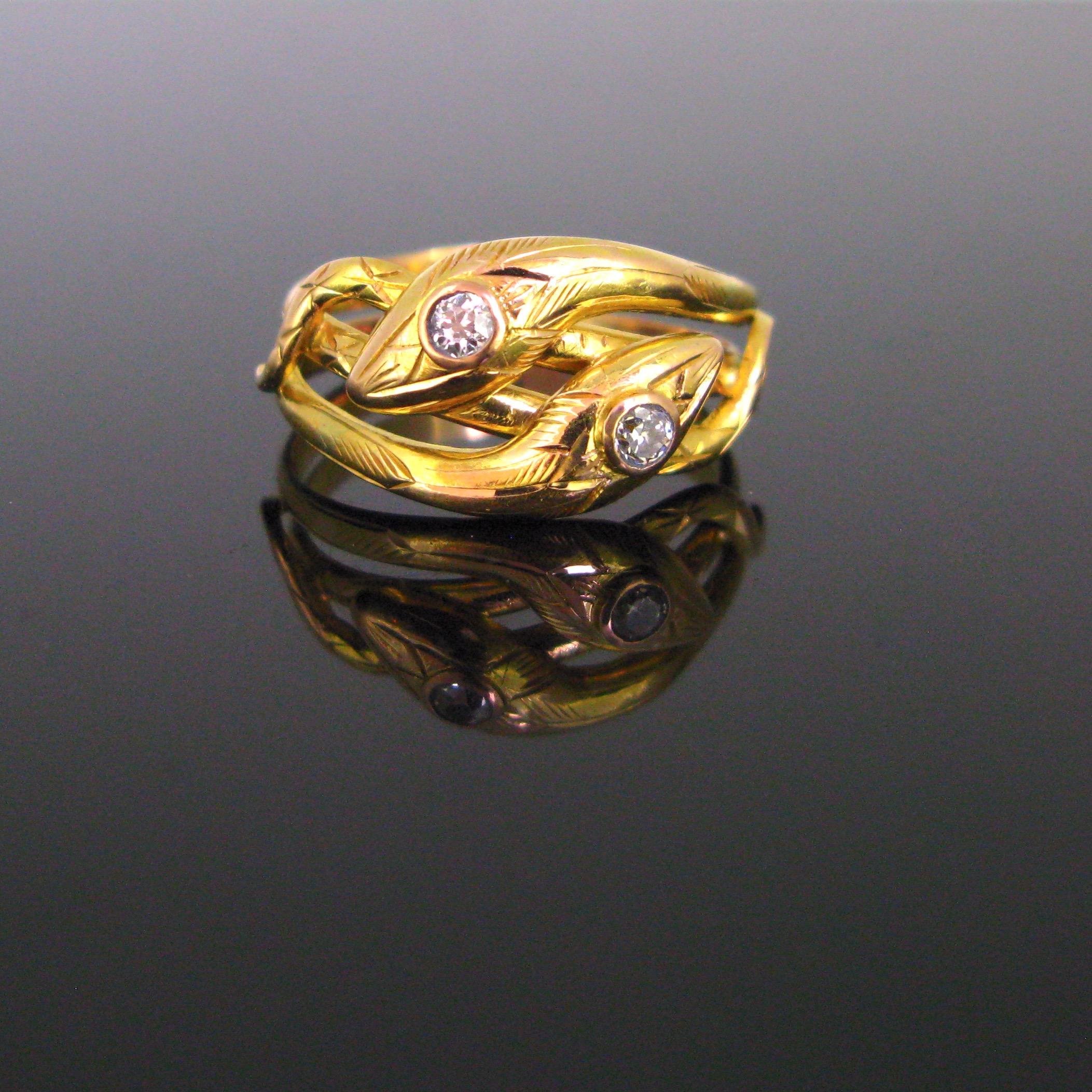 This ravishing ring features two intertwined snakes. Their heads are adorned with a diamond. This type of ring is a real testimony design inspired by the Victorian period. Snakes may frighten a lot but they were a universally popular expression of
