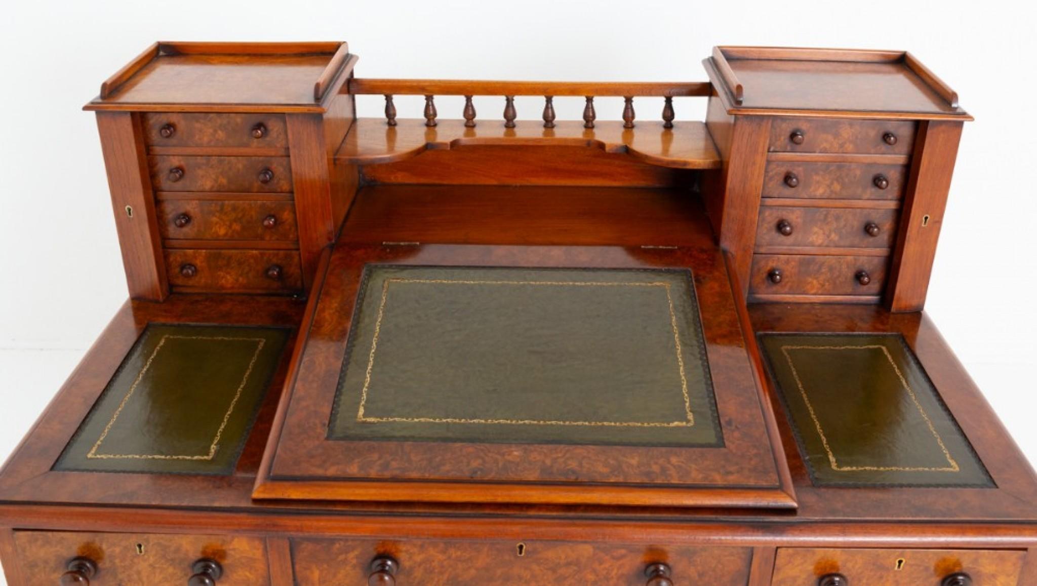 Victorian Burr Walnut ''Dickens'' Desk.1
This ''Dickens'' desk having an arrangement of 9 mahogany lined drawers.
Circa 1870
The centre drawer being of a faux example.
The drawer retain their original turned knobs and locks.
The writing slope having