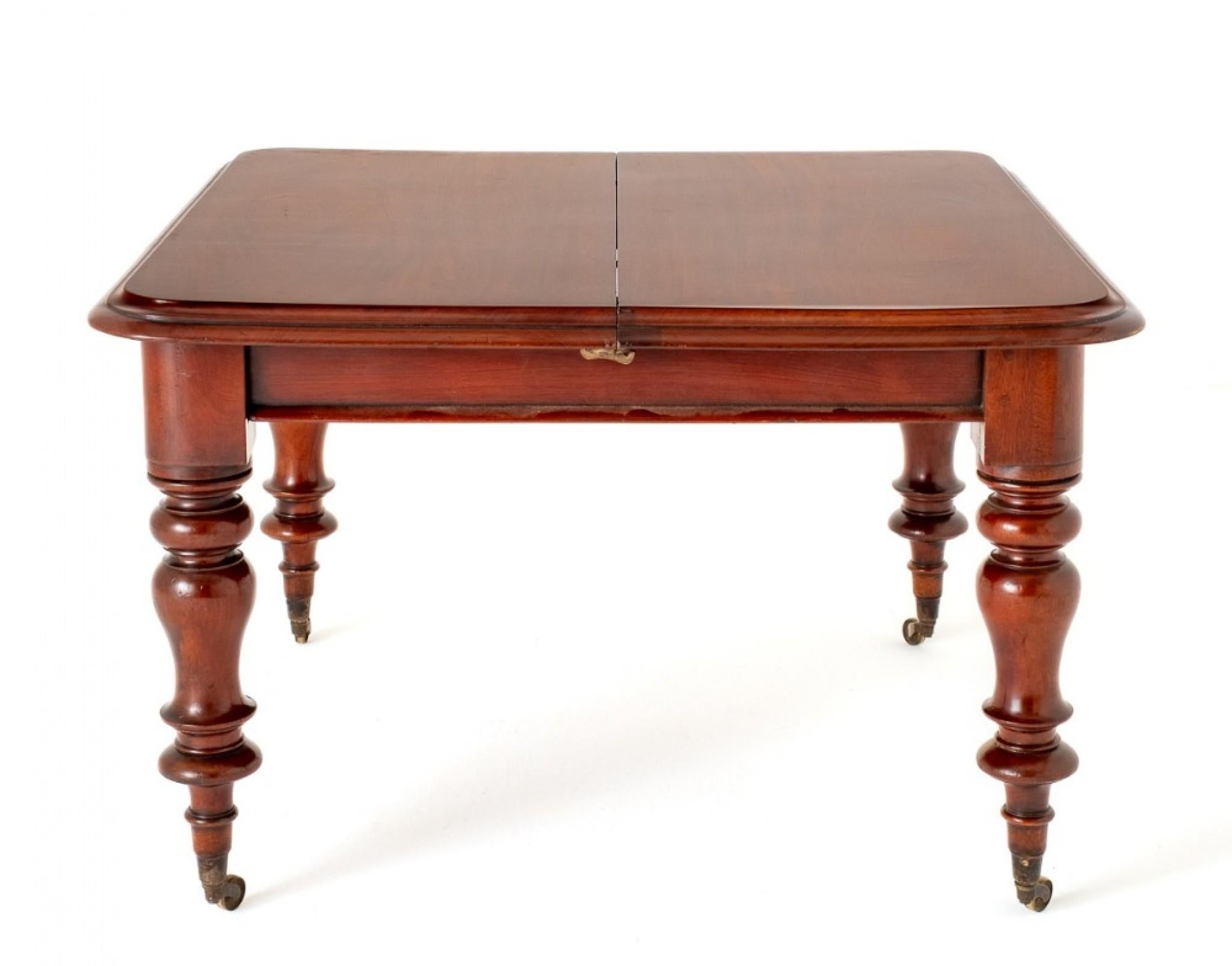 Victorian Mahogany 2 Leaf Extending Dining Table.
Circa 1860
This Dining Table is Raised upon Ring Turned Legs with Original Brass castors.
The Table Extends By Way of a Pullout Telescopic Mechanism to accept up to 2 Extra Leaves.
The Top of the