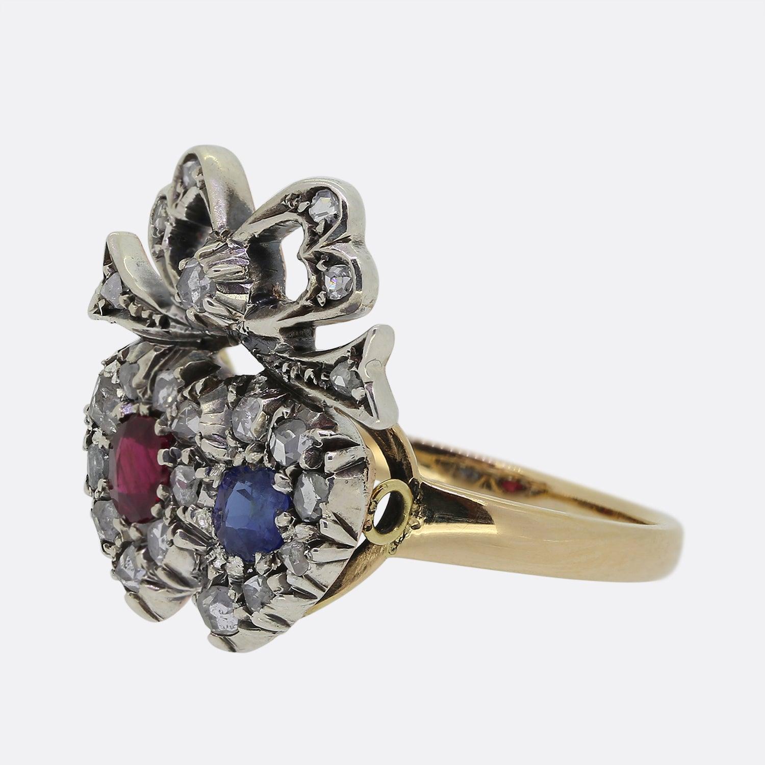 Here we have a fine example of a Victorian double heart ring. In this case, a round ruby and sapphire sit at the centre of an accentuating boarder of rose cut diamonds. A conjoining rose cut diamond encrusted crown motif lies atop in platinum