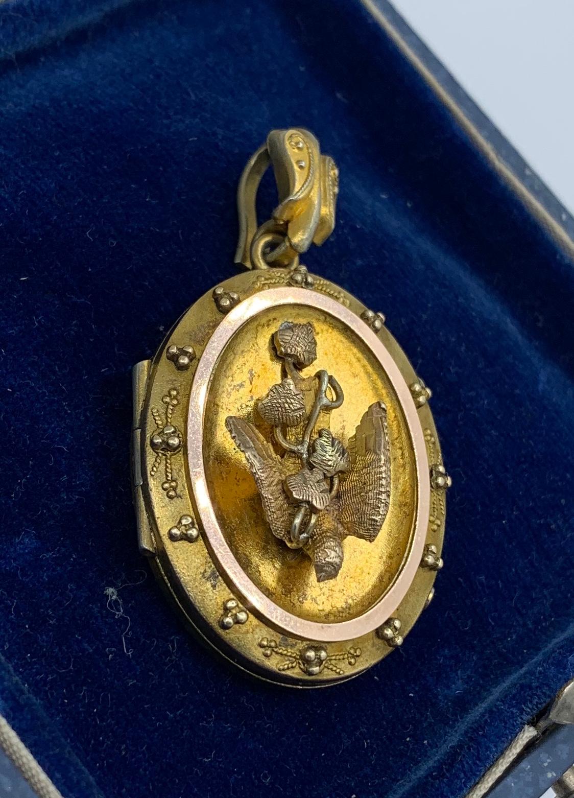 This is a magnificent Victorian - Belle Epoque Picture Locket Pendant with a stunning fully modeled three dimensional dove swallow bird on the front.  The locket has gorgeous Etruscan Revival granulation adornment around the bird who carries a