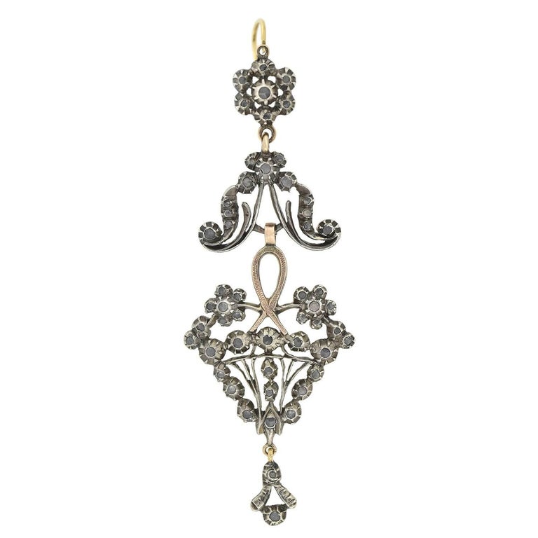 A gorgeous pair of ornate wirework diamond earrings from the early Victorian (ca1850) era! These fantastic earrings have a dramatic dangling design crafted in 15kt rose gold topped in sterling silver for a subtle two-tone effect. Each earring