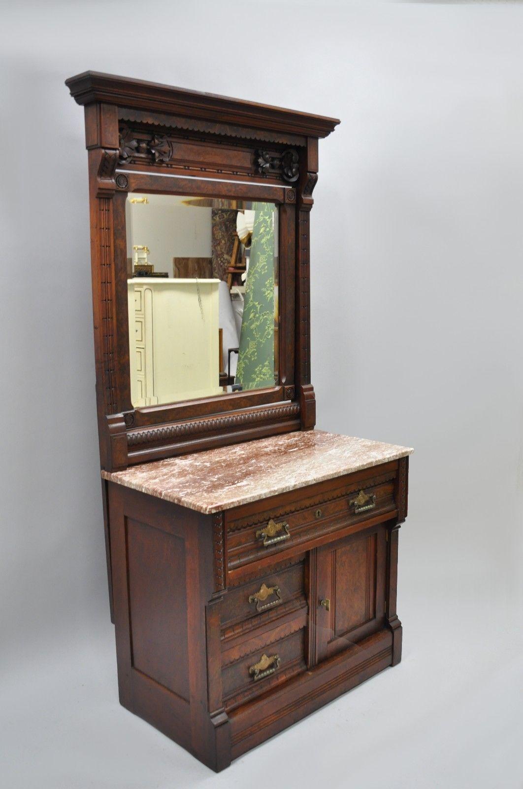 Antique Eastlake Victorian burl walnut marble-top wash stand chest with mirror. Item features beautiful wood grain, pivoting beveled glass mirror, marble top, three dovetailed drawers, and one swing door, circa mid-1800s. Measurements: 68