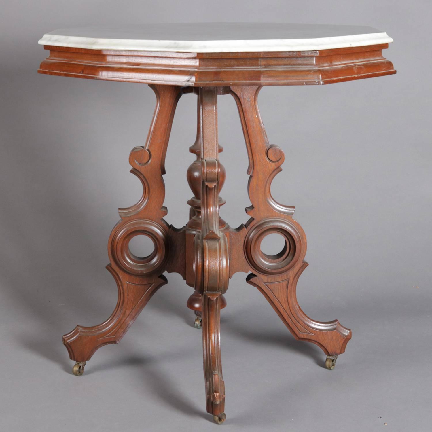 Victorian Eastlake parlor table features beveled marble top above incised and carved and pierced walnut base with incised decorated stylized scroll form legs with turned center plinth, 19th century

***DELIVERY NOTICE – Due to COVID-19 we are