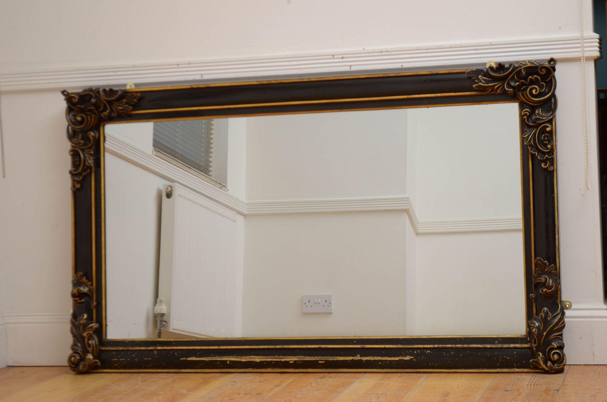 Sn5510 Stylish Victorian ebonised wall mirror, having original glass with some imperfections in moulded and shaped ebonised frame with fine floral carvings to corners. This antique mirror was refinished in the past, now showing minor usage marks,