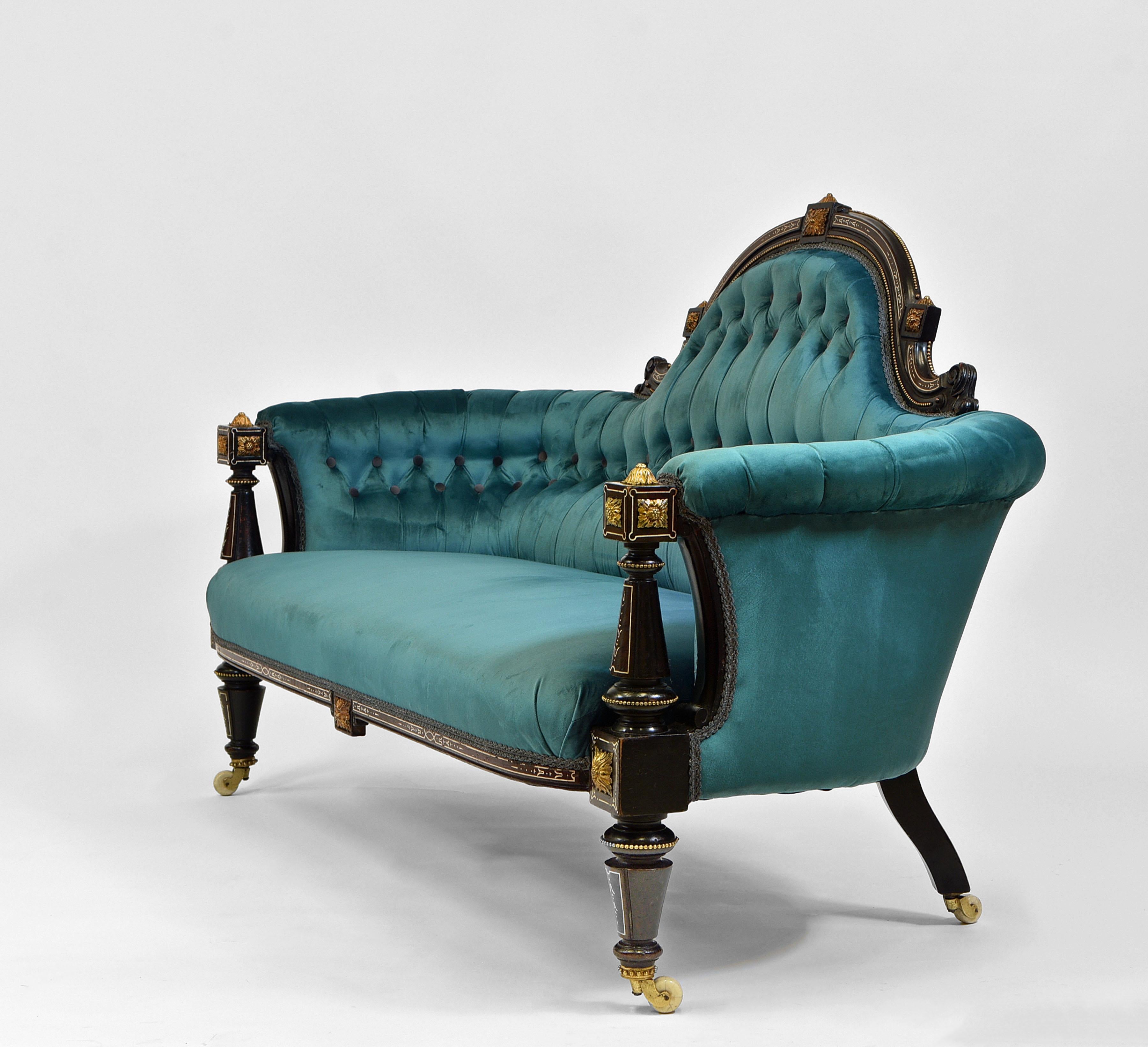 A fabulous English mid-19th century ebonised and gilt bronzed mounted, button backed velvet sofa. Circa 1860.

The sofa has been fully re-sprung, reupholstered and covered in Designer's Guild teal velvet, with contrasting charcoal velvet buttons to