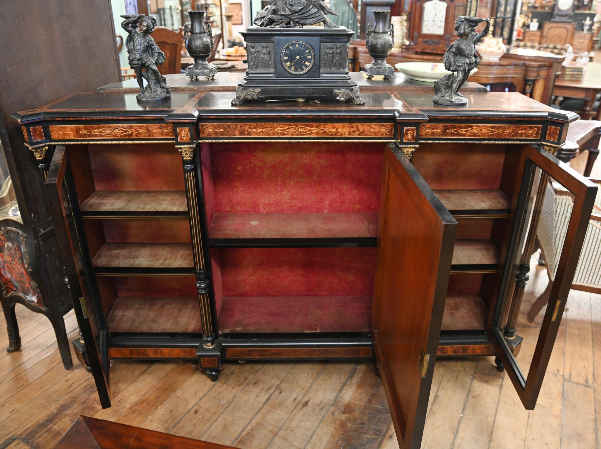 Gorgeous large size Victorian ebonised credenza or sideboard
Inlaid with exotic woods and features amboyna wood extensively
Luxurious look with the interplay between the colours of the different woods
Four column supports and Sevres porcelain