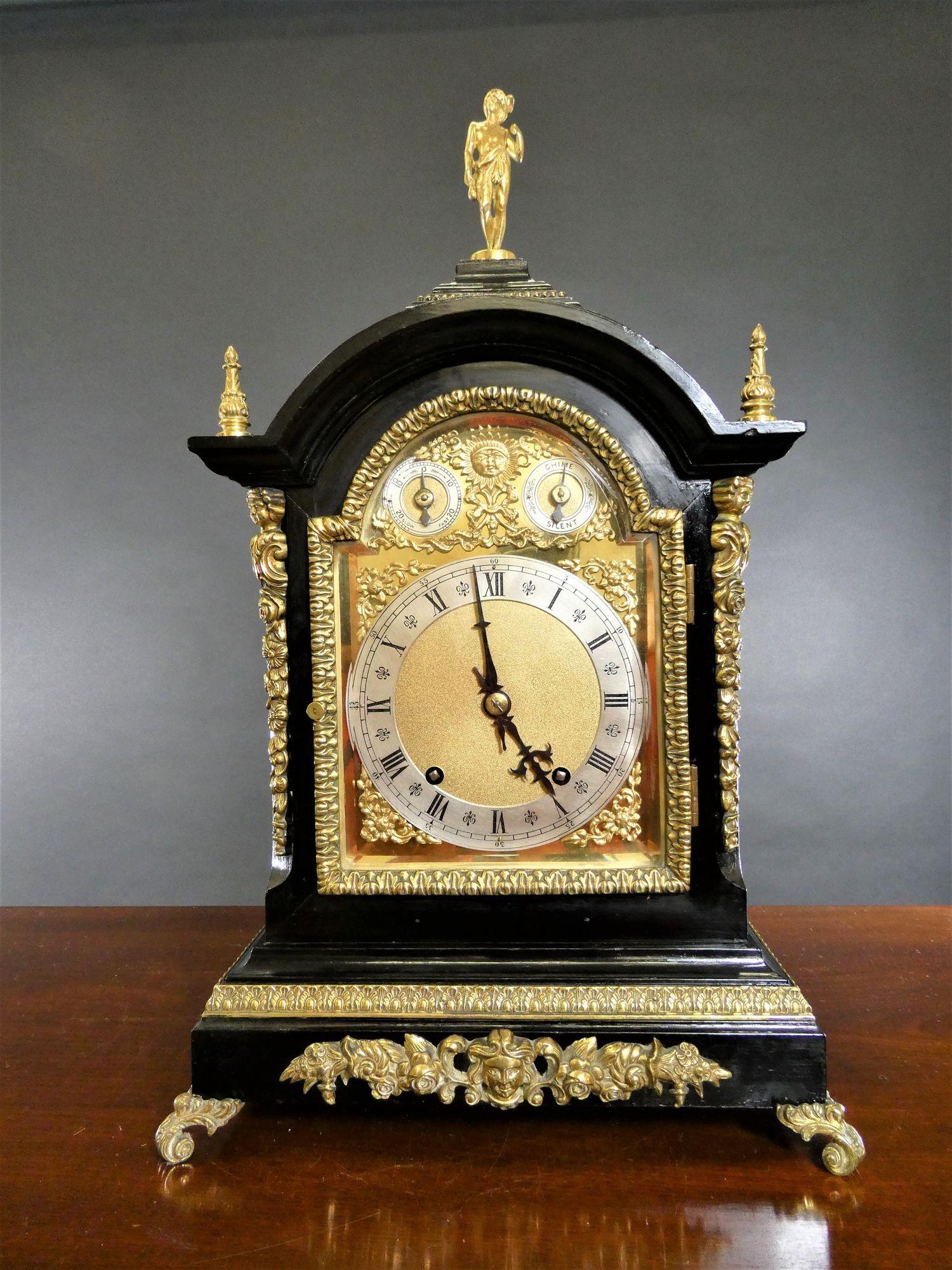 Victorian Ebonised ting-tang chiming bracket clock
 
Impressive ebonised break arch case with finely cast ormolu mounts, raised stepped plinth resting on outswept cast bracket feet, surmounted by gilded finials and pad top with ormolu figure. The