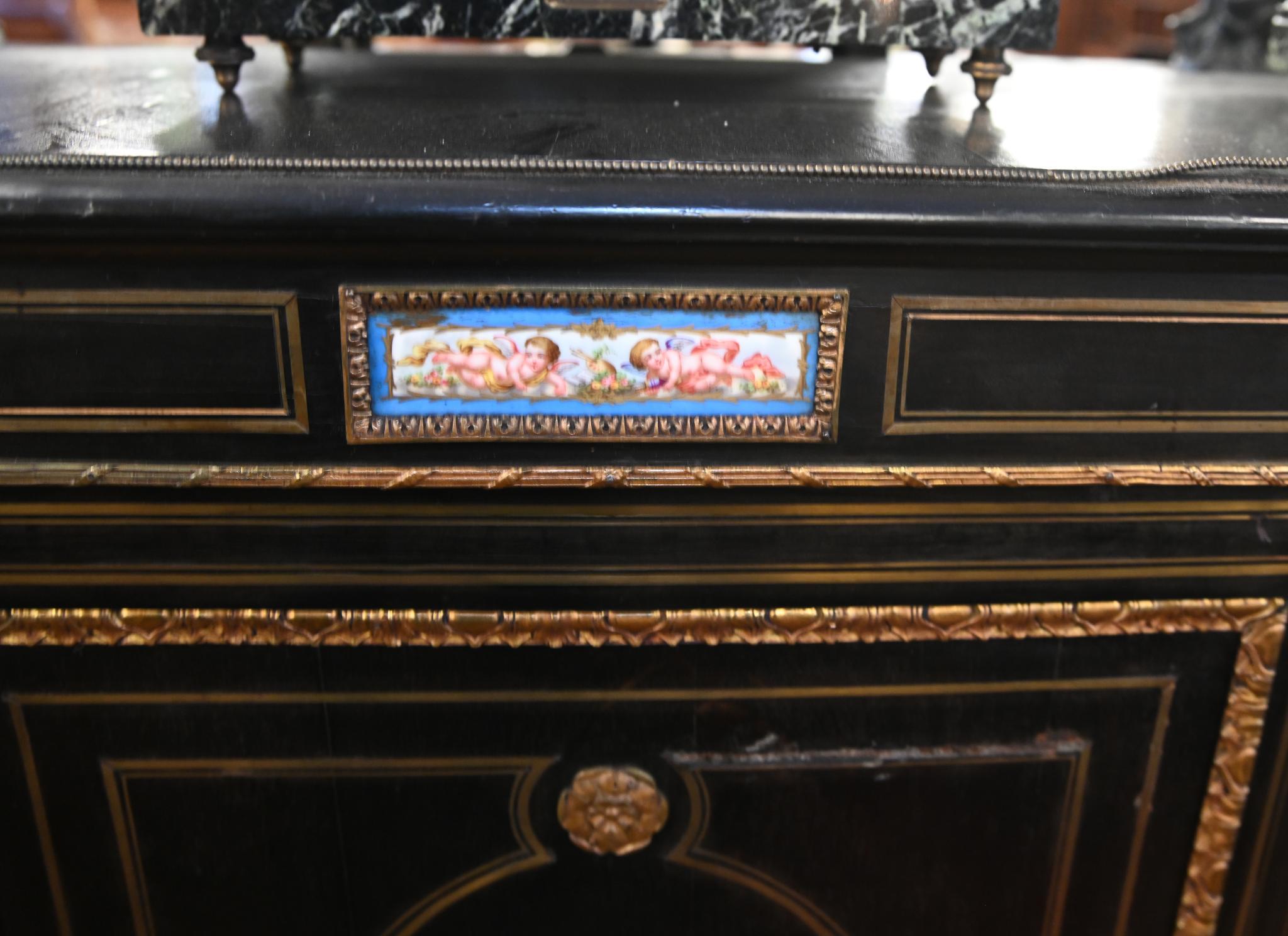 Ebonised Victorian high quality credenza with ormulo mounts and Sevres plaques
Circa 1880
Two glass doors either side with shelving area for displaying pieces
Hand painted porcelain plaques show floral sprays and Romantic scenes
Love the colour