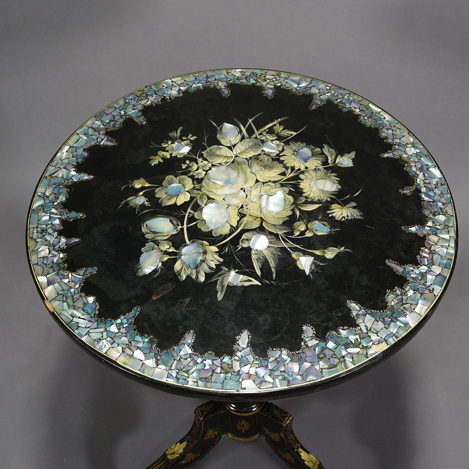 A wonderful ebonized side table made of wood. Rotable tabletop with mother of pearl inlays and flower paintings. Base decorated with gilded floral paintings. Probably, French, circa 1890. Good condition with some paint abreasions on top and