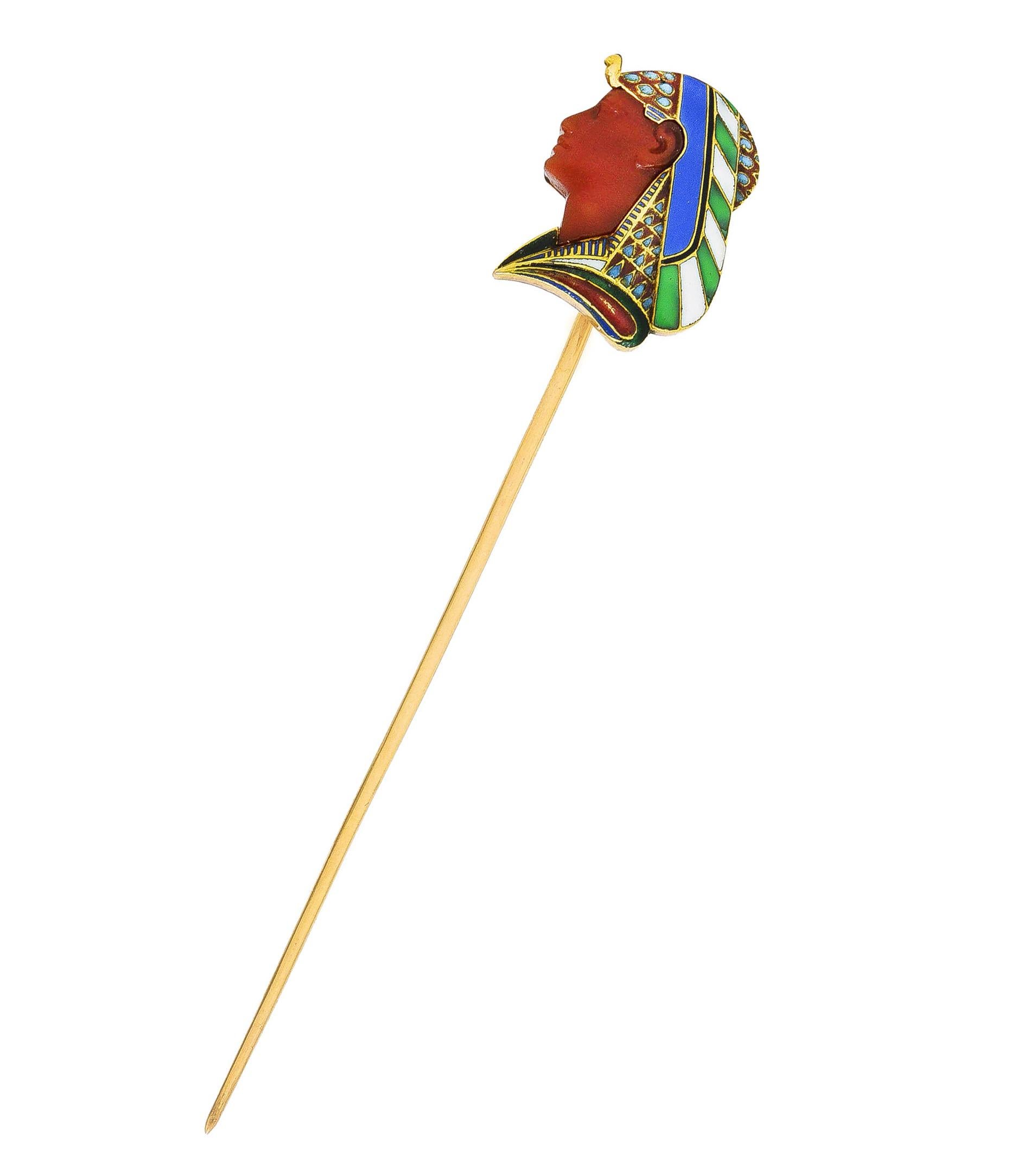 Stickpin is designed as the profiled bust of a pharaoh wearing a decorative headdress. Featuring enamel detailing - opaque blue, green, white, red, and black - minimal loss. With a carved carnelian face - translucent reddish orange with matte