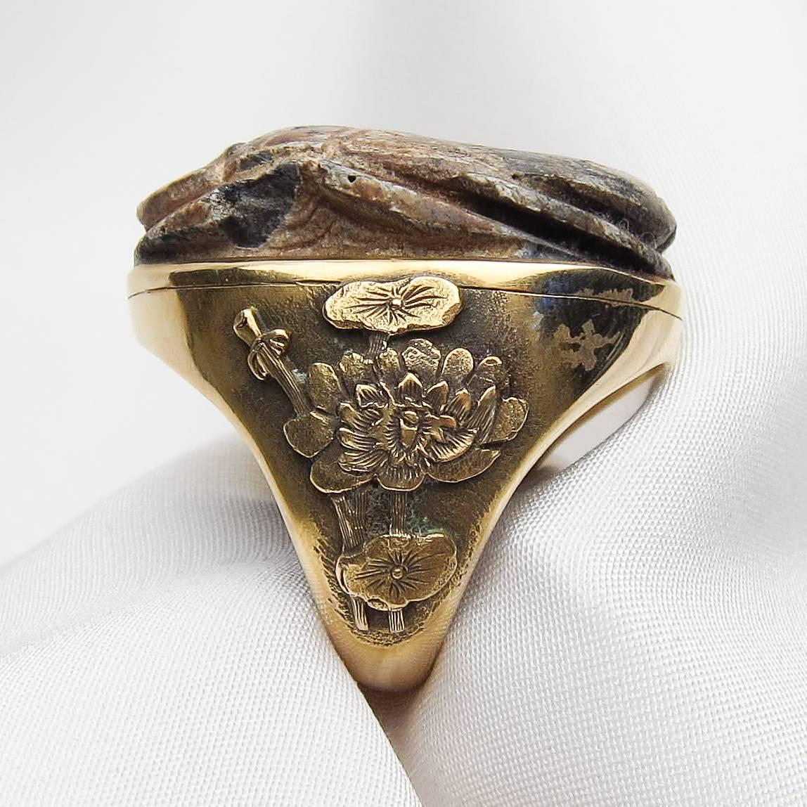 Circa 1880. This amazing Victorian cocktail ring features a large carved scarab made from a non-clay, glazed ceramic material similar to glass, also known as 
