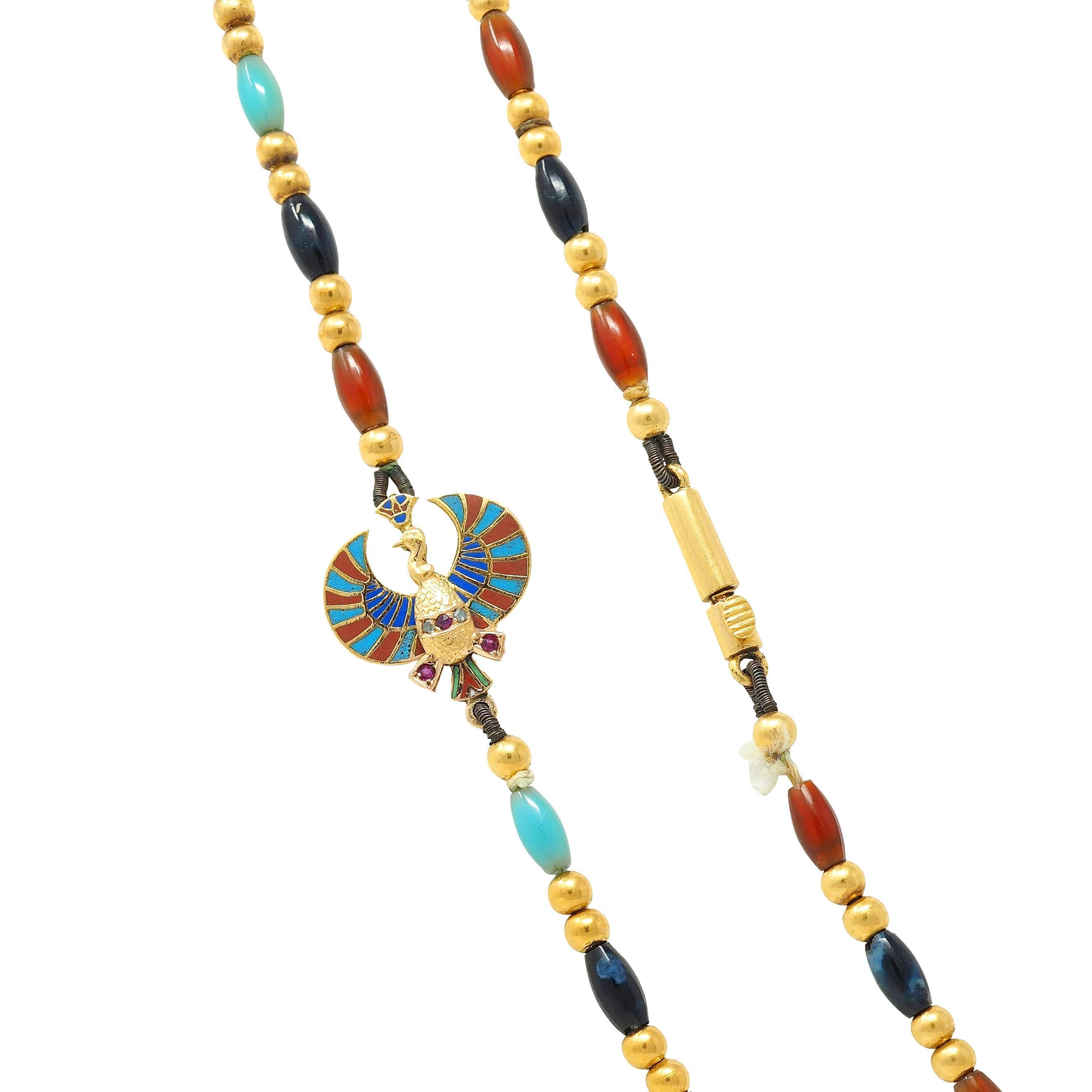 Designed as a beaded multi-gem strand with scarab and bird motif stations 
Comprised of turquoise, carnelian, and lapis lazuli barrel beads
Opaque light blue, medium blue, and translucent reddish-orange in color, respectively
Measuring 3.0 x 6.0 mm