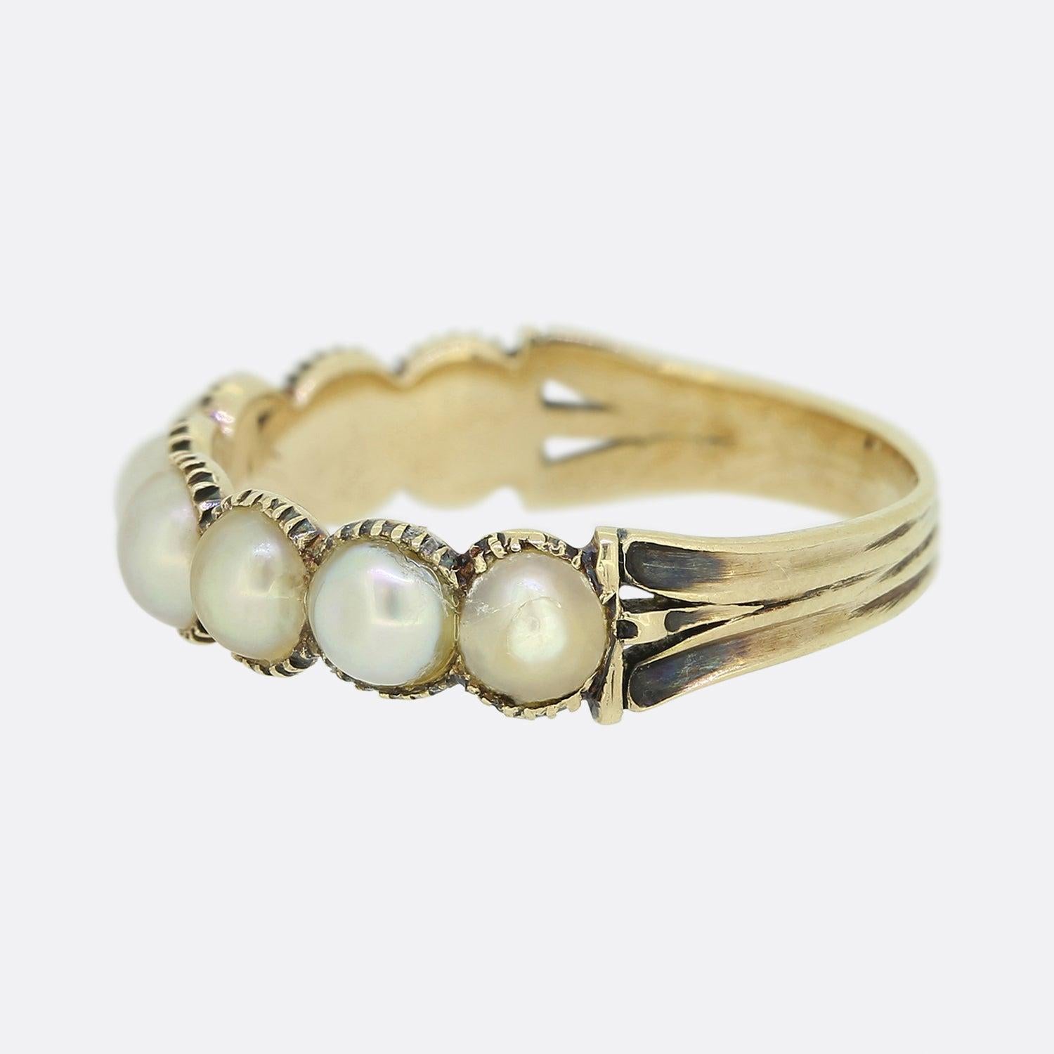 Here we have a pearl set ring from the early stages of the Victorian period. A split 18ct yellow gold band plays host to eight round natural pearls; all of which have been individually claw set in a single line formation across the face.