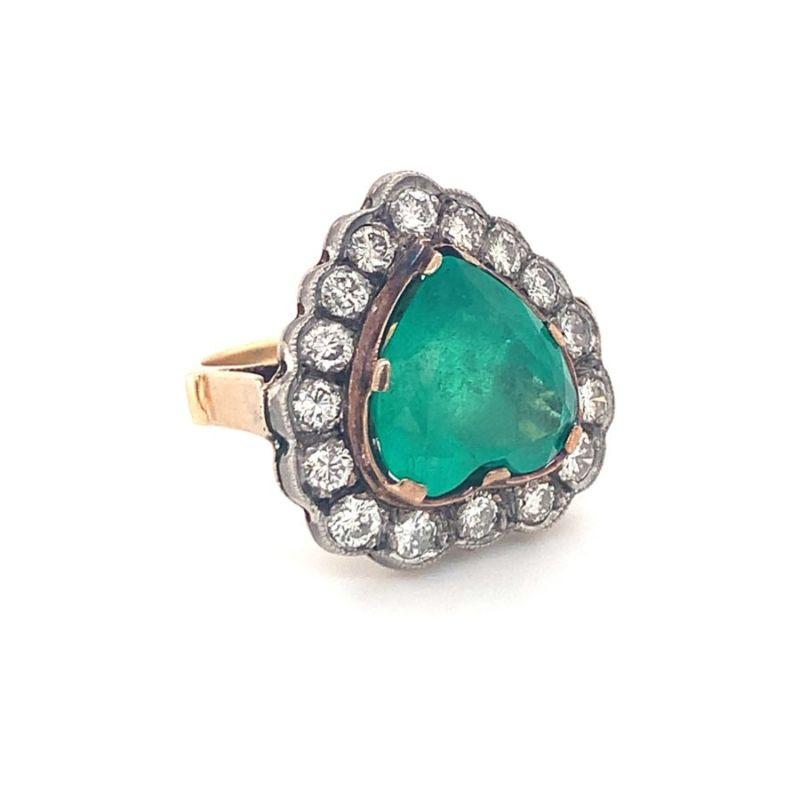 One Victorian emerald and diamond 14K yellow gold, silver topped emerald ring featuring 1 heart shaped emerald weighing 5 ct. Enhanced by 16 round brilliant cut diamonds totaling 1 ct. Circa 1910.

Delightful, playful, antique.

Additional