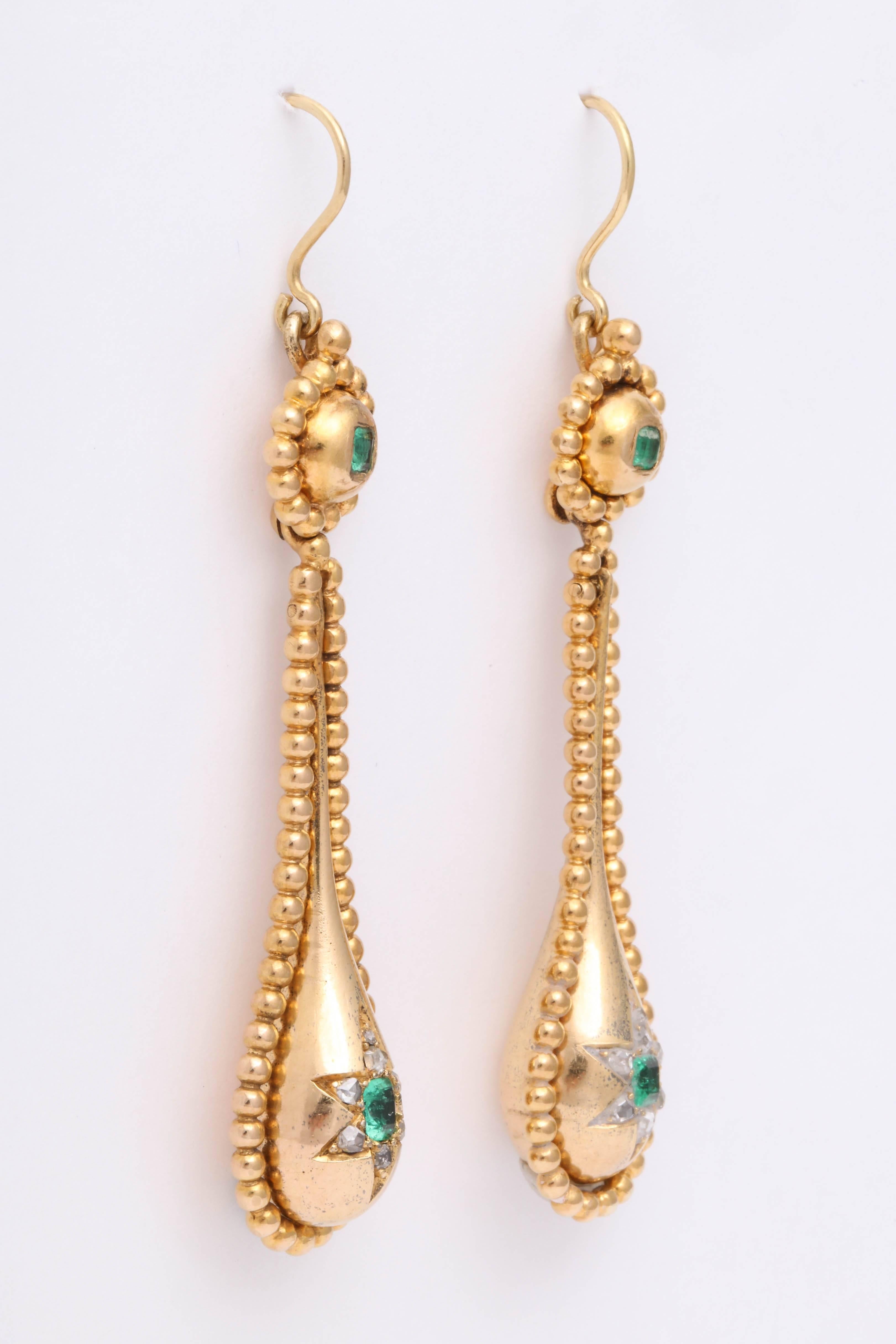 English earrings set with emeralds and diamonds in 18K yellow gold dating to the Victorian era.