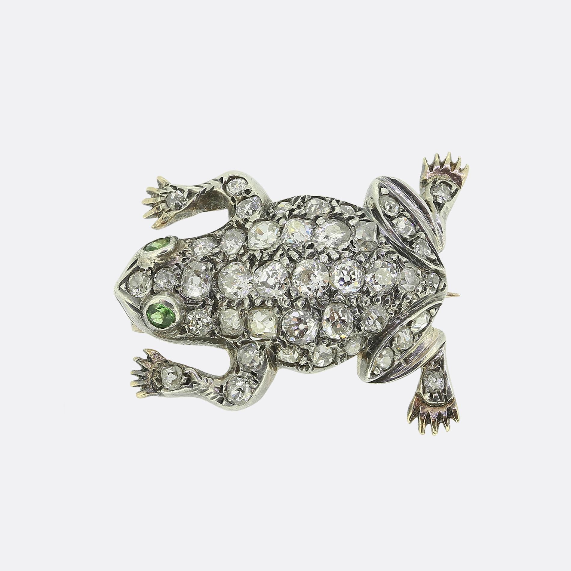 Here we have a fun and quirky brooch taken from the Victorian period. This antique piece is crafted from 18ct gold and silver into the shape of a frog. The design is adorned with a array of closely claw set round faceted white old cut diamonds,