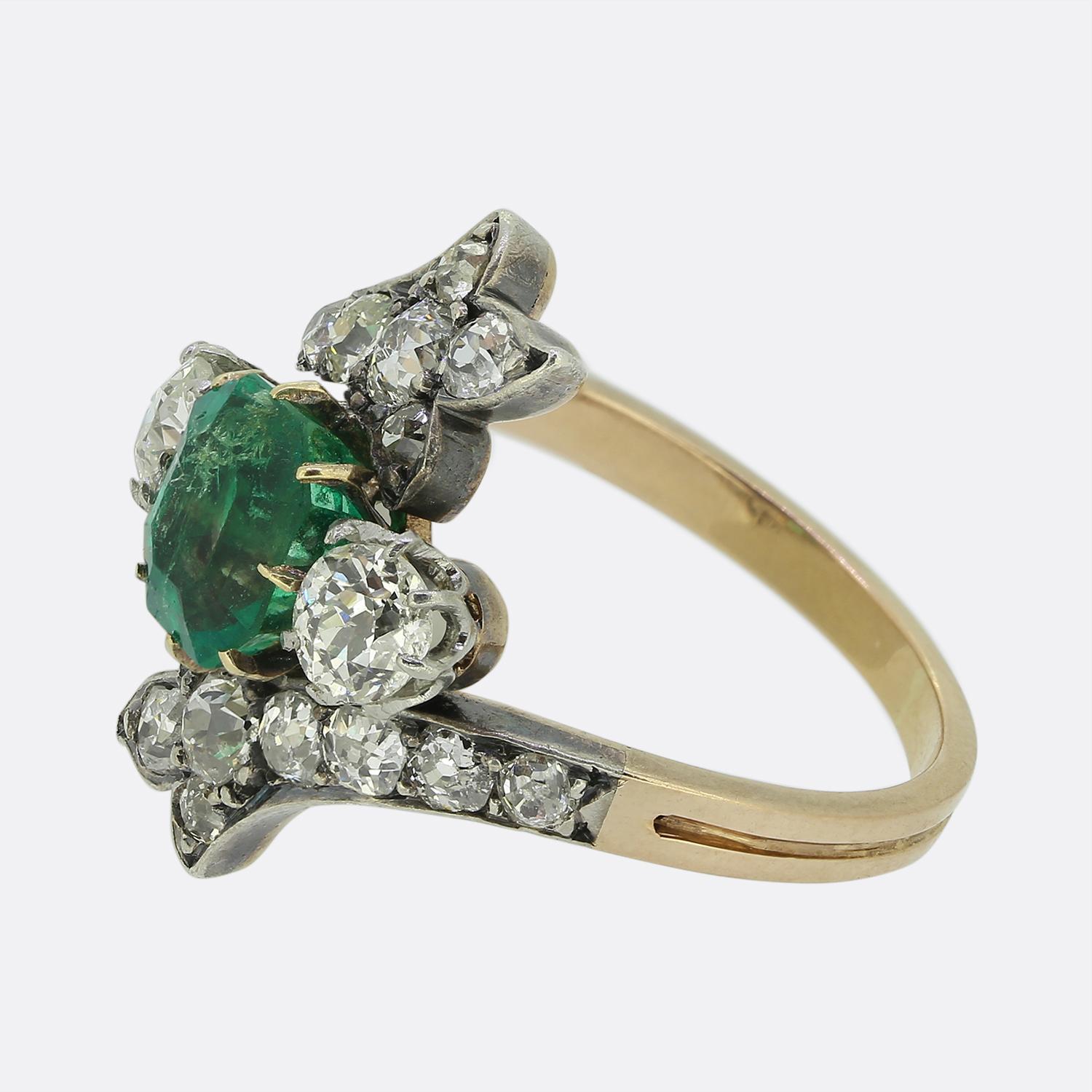 Here we have a delightful Victorian ring showcasing a captivating emerald-cut emerald at its centre, radiating a rich green hue. Flanking this principal stone is pair of dazzling round faceted old European cut diamonds, each set in a graceful
