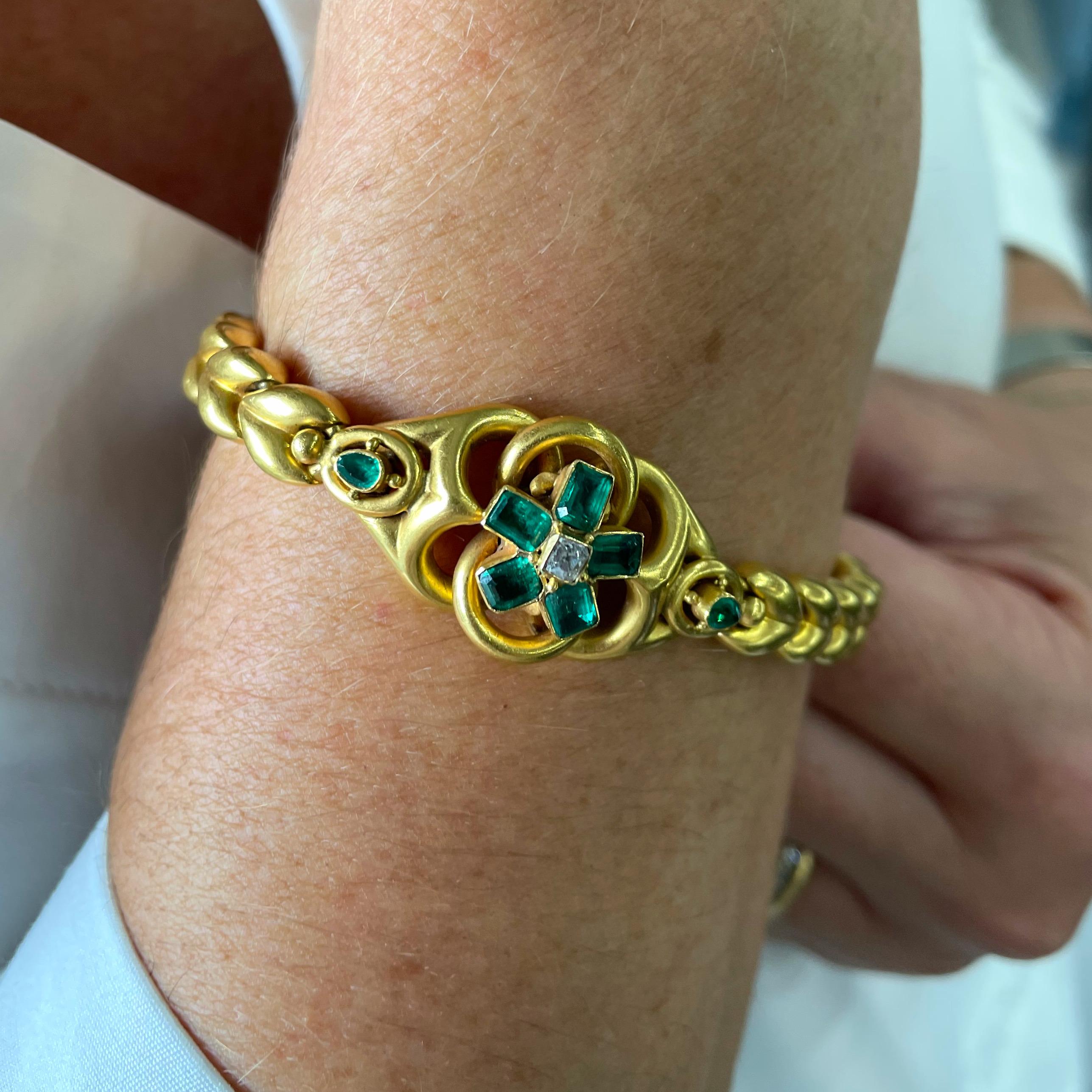 A Victorian gold and emerald bracelet, with an old-cut diamond in the centre surrounded by five step-cut emeralds, in the middle of a gold motif, with a pear shape emerald on each shoulder. With a hair locket mounted in the back. Circa 1880.
The
