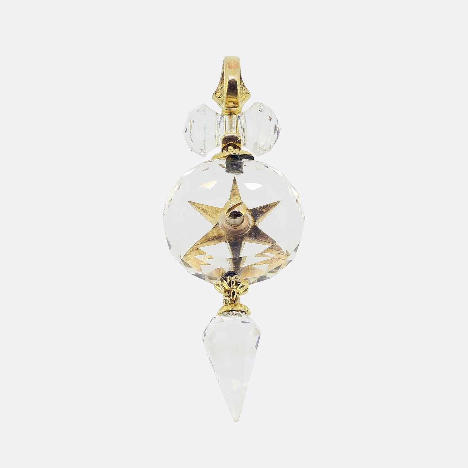 Here we have an exquisite drop pendant showcasing a harmonious blend of rock crystal, emeralds and diamonds. This piece, crafted with precision, features a colourless rock crystal sphere as its centrepiece. Adorning the sphere is a striking star