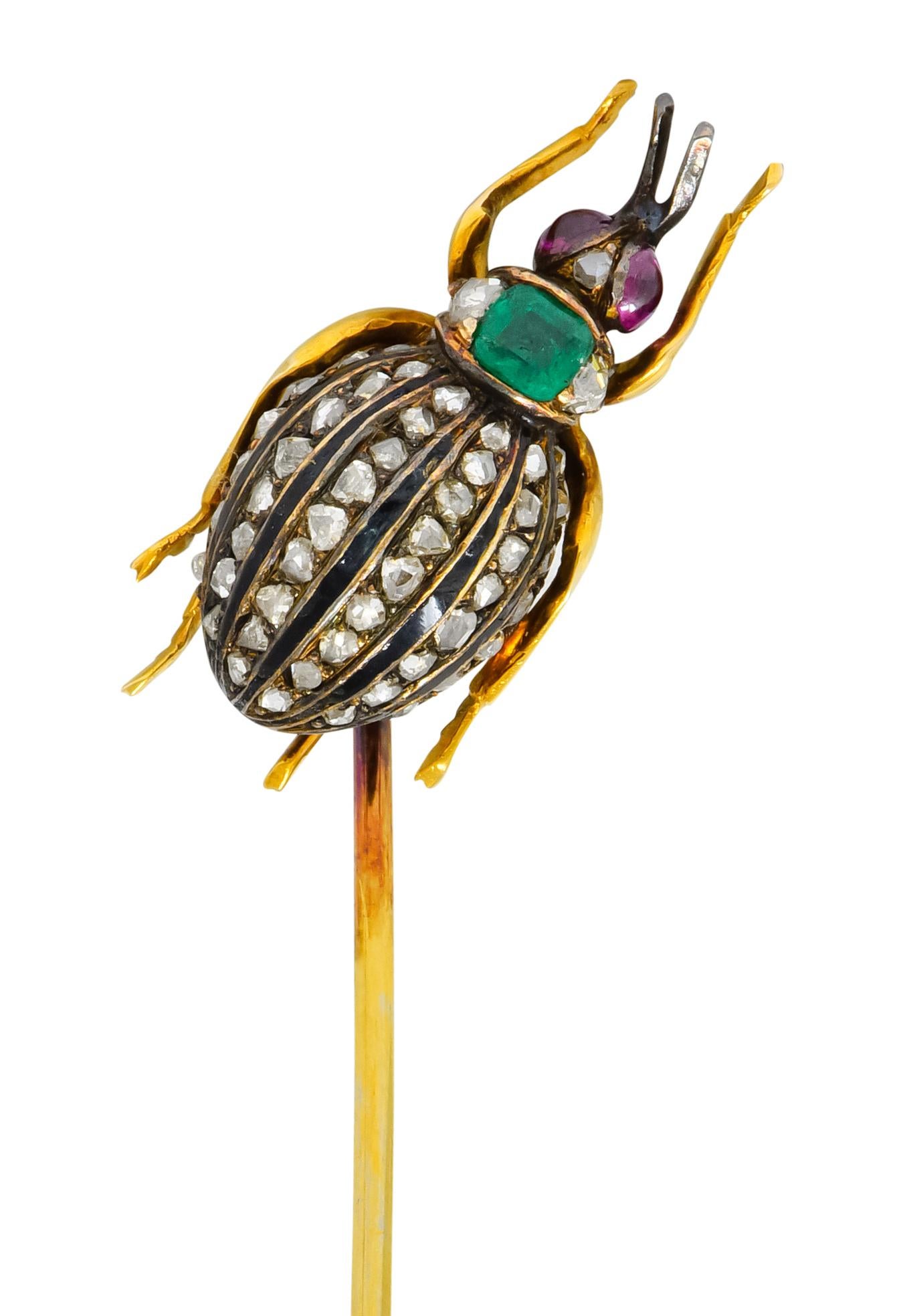 Designed as a weevil insect with a largely domed abdomen decorated with lines of rose cut diamonds alternating with black enamel stripes

Thorax is comprised of central cushion cut emerald, transparent and bright verdant green in color, flanked by
