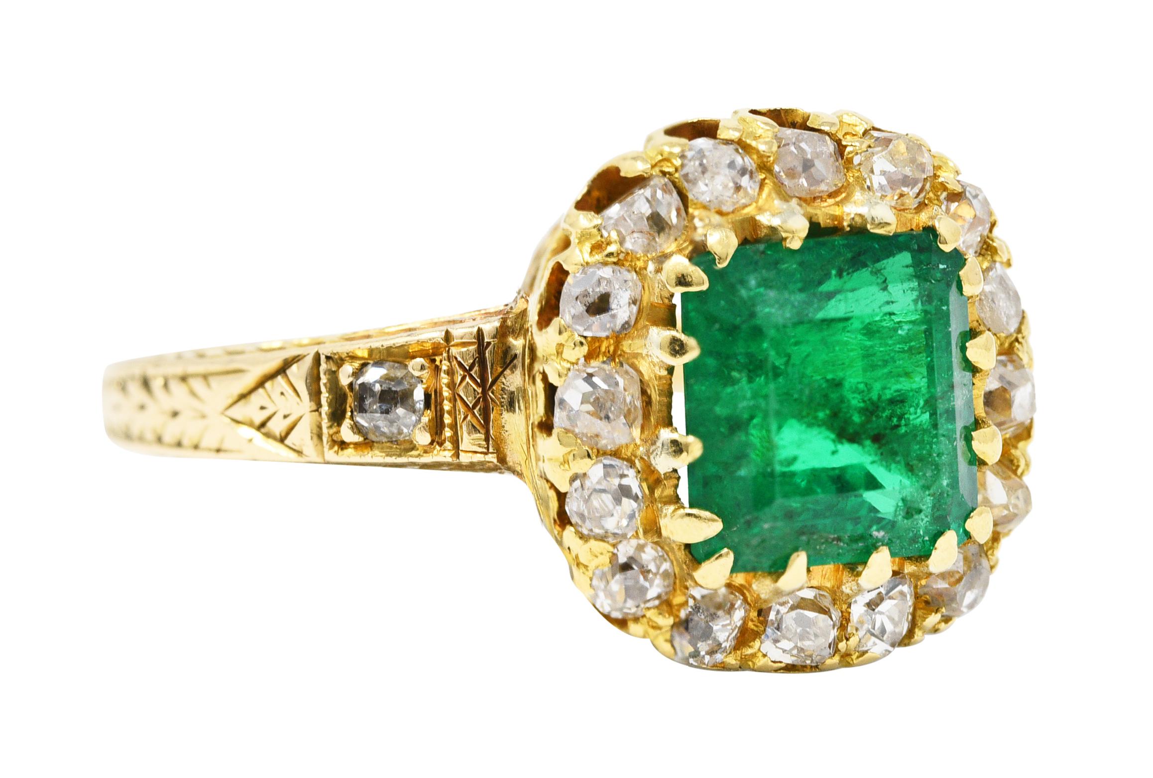 Centering a square emerald cut emerald weighing approximately 1.52 carats. Transparent vibrant green with medium saturation and natural inclusions. Prong set with a halo surround and shoulders set with old mine cut diamonds. Bead and prong set and