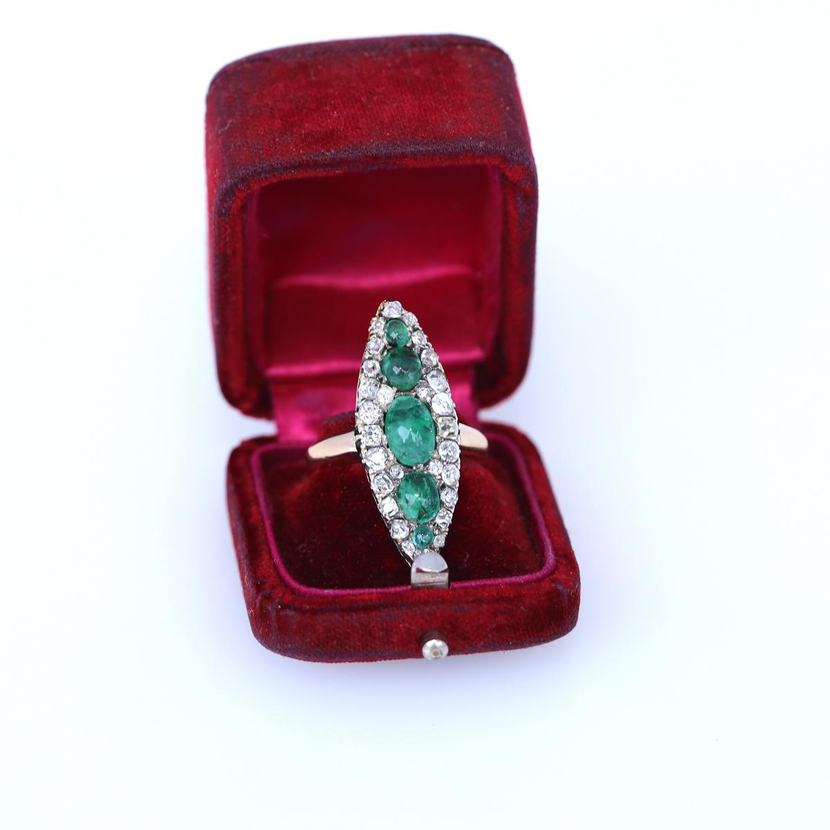 Victorian Emeralds Diamonds Navette Gold Silver, 1880.
Victorian period navette-shaped ring with Cabochon Emeralds and old-cut Diamonds. A really great example of the era. Delicate elegant and stylish. The Emeralds are of lovely green shade and fine