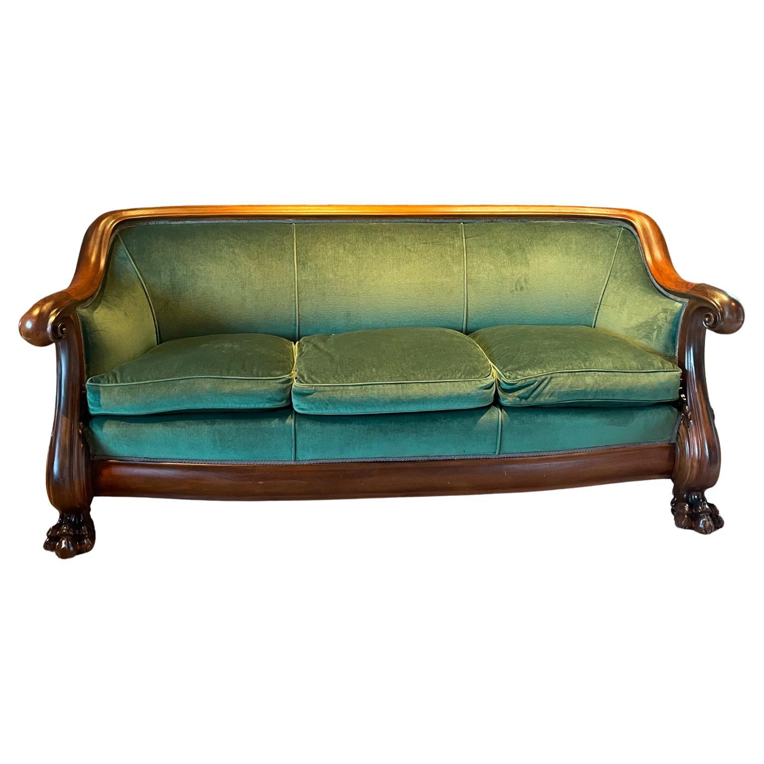 Victoria empire settee three-seater sofa hand carved mahogany green velvet
Comfortable elegance, quality and craftsmanship outstanding
made in the USA 1920s
37.5 h x 85.5 w x 32.5 d seat 22 arm 30.5 h
Solid mahogany wood with lion paw feet. 
Legs