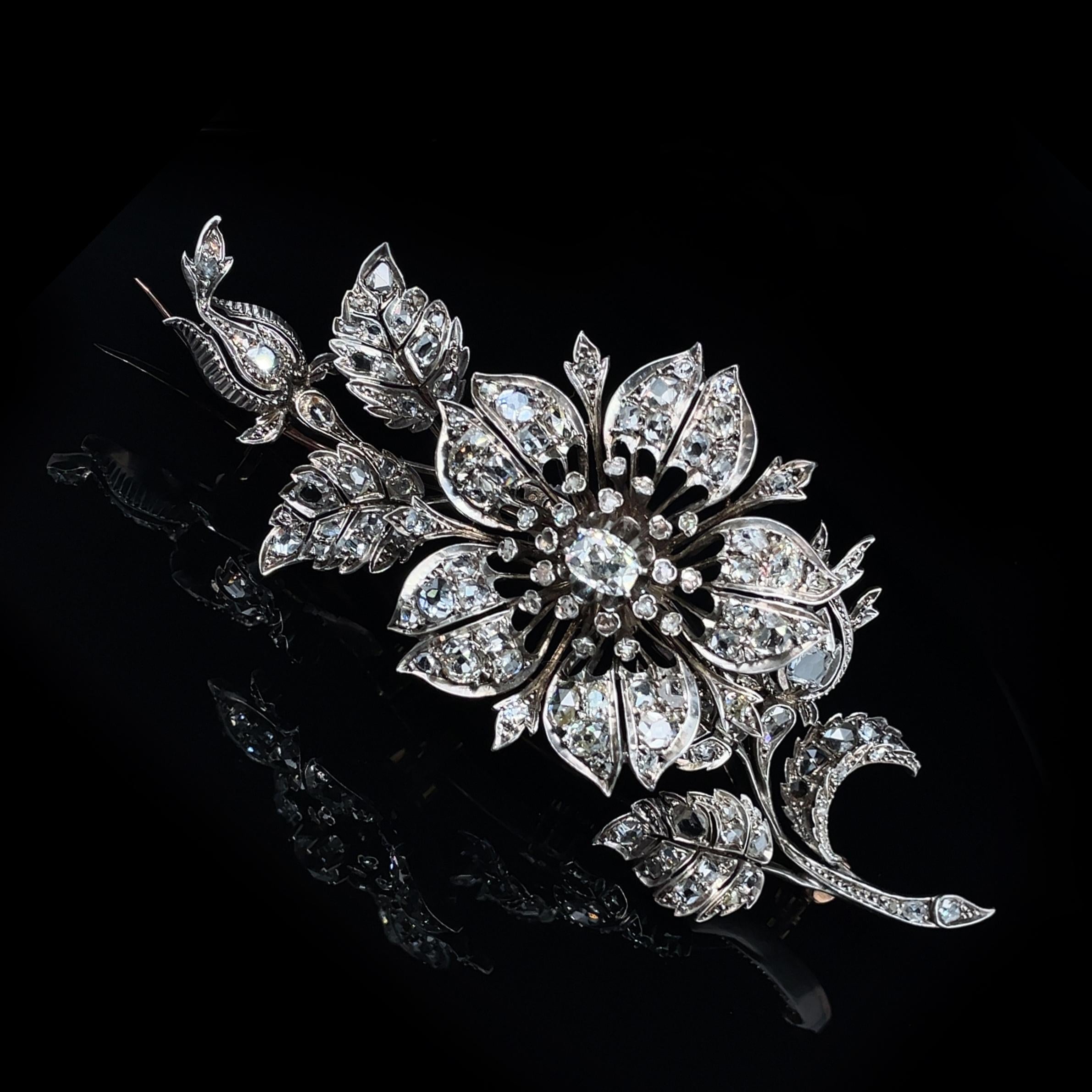 Large Victorian En Tremblant Diamond Flower Brooch, ca. 1880s

A beautiful Victorian flower brooch set with old-mine cut and rose-cut diamonds of ca. 10-11 carats. 
The brooch is very realistically made and the central flower bud has an excellent en