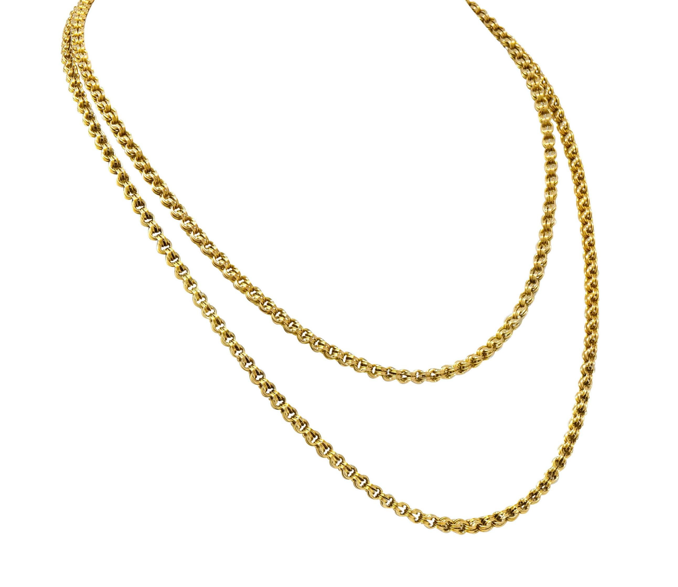 Rolo style chain necklace comprised of doubled round links that are deeply grooved

Completed by a barrel clasp featuring decorative black enamel detail

Tested as 10 karat gold

Length: 34 inches

Width at widest: 3/16 inch

Total weight: 21.0