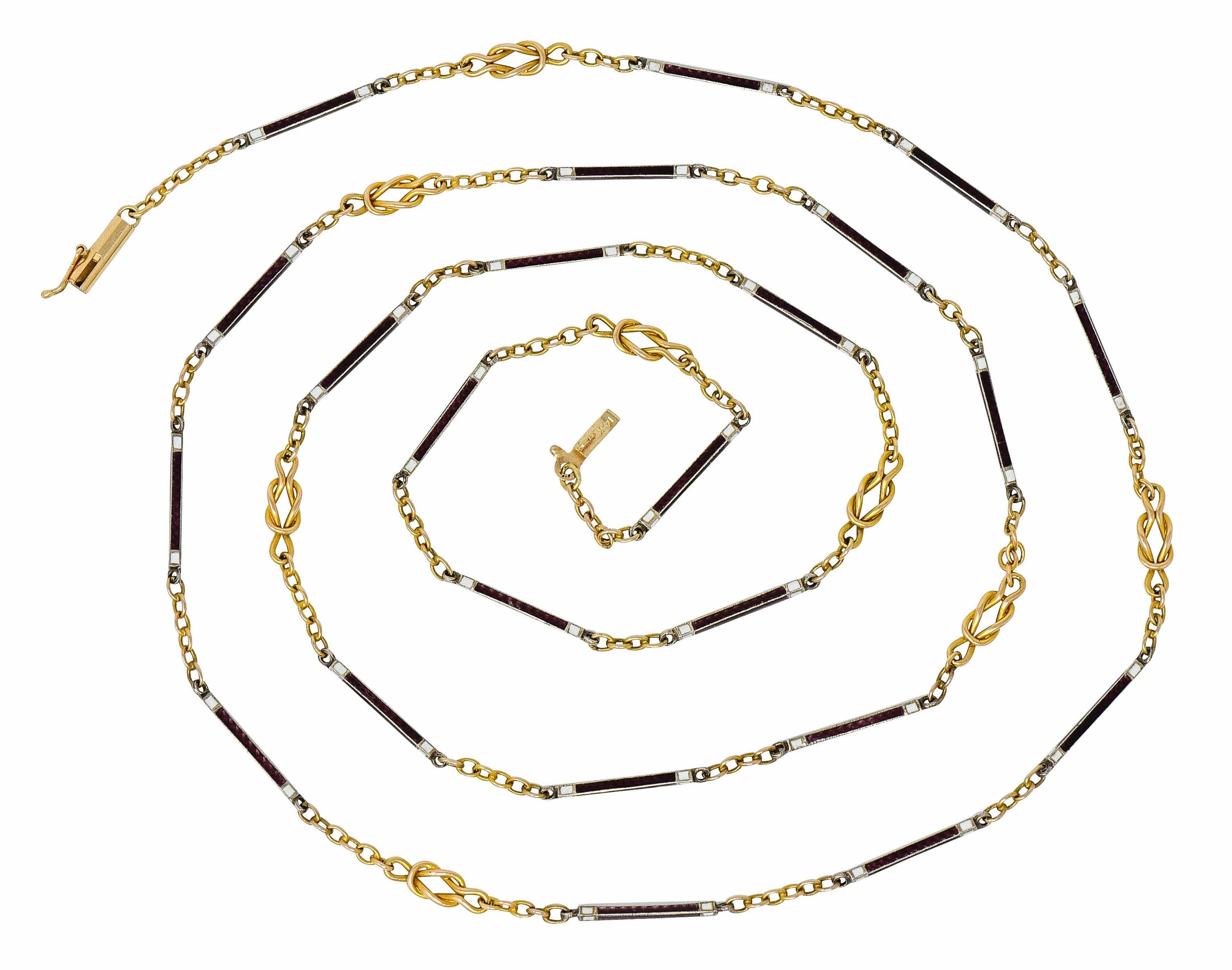 Long station style necklace featuring bar links glossed with burgundy and white enamel; exhibiting very little loss

Alternating with twisted gold stations depicting a looped sailor's reef knot motif

Completed by cable chain spacer links and