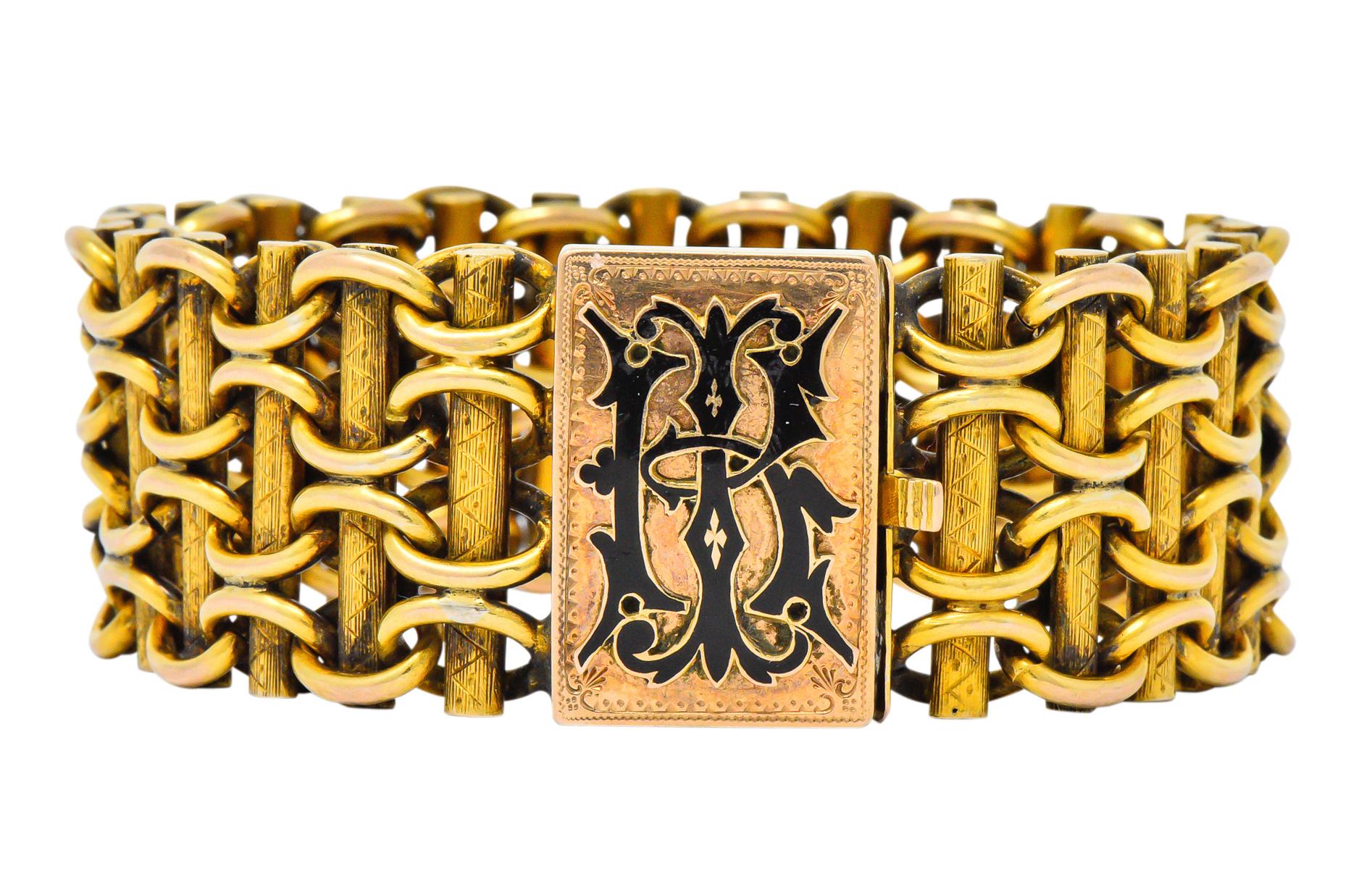 Wide decorative links, with textured gold bars threaded through polished gold links

Completed by a box clasp with raised black enamel monogram on a detailed engraved gold background 

Tested as 14 karat, stamped ‘A’ and with maker’s mark

Length: 7