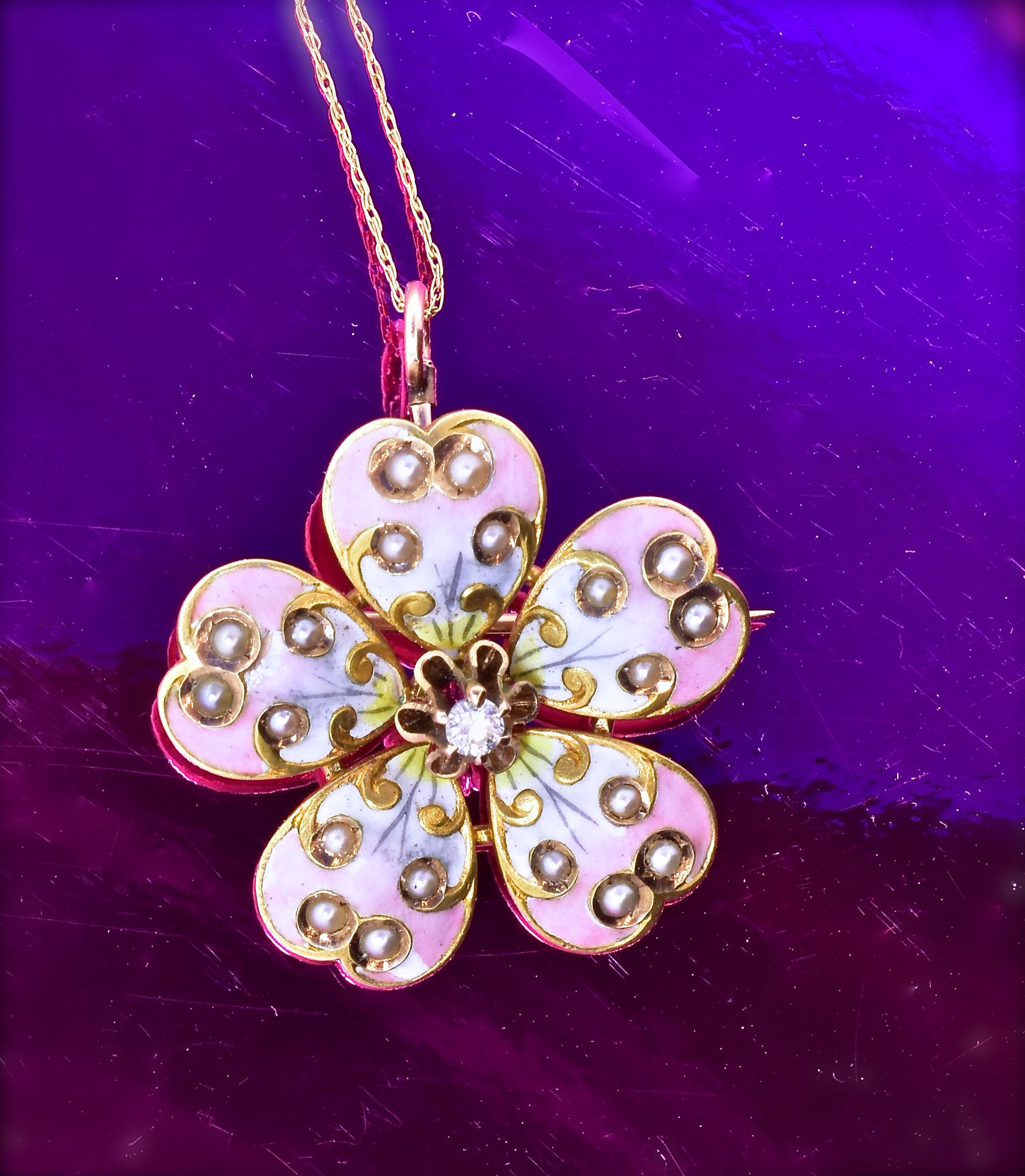 Antique enamel flower with shaded enamel to depict the flower's heart shaped petals, with 20 natural seed pearls set in the petals and an .08 ct. old cut diamond at the center.  This charming piece in fine condition, with a very slight wear to the