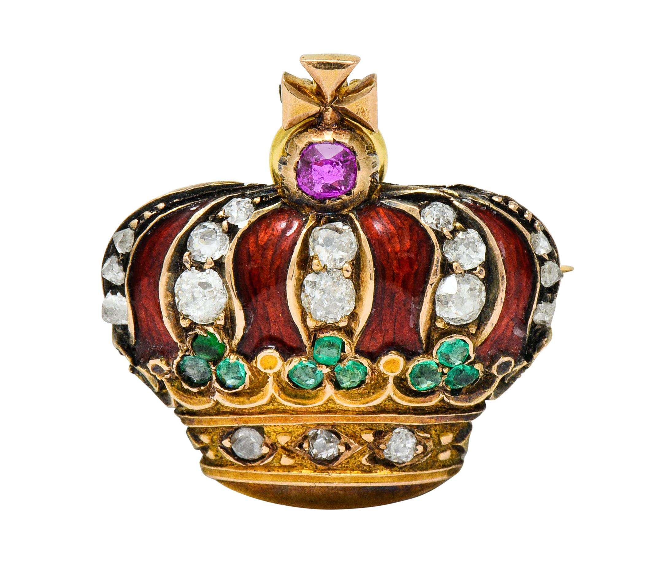 Designed as a cushioned imperial crown topped by a maltese cross accented by a cushion cut ruby weighing approximately 0.20 carat; bright pinkish-red

Cushioned area is glossed a bold brick red with enamel and exhibits no loss

With a trefoil motif