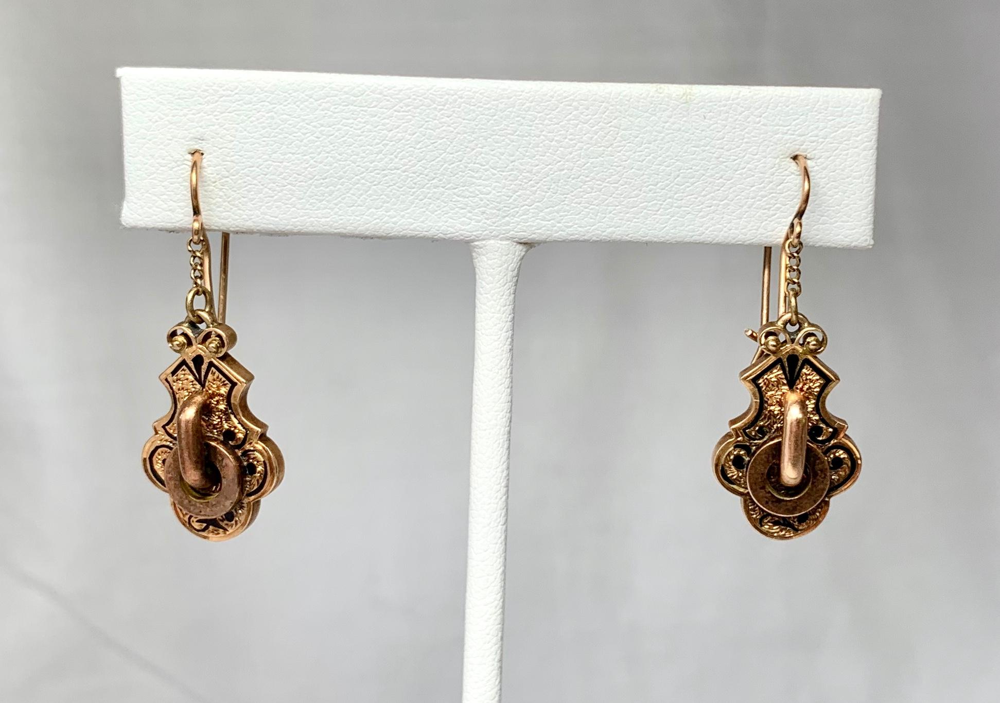 A beautiful pair of Antique Victorian 14 Karat Gold Door Knocker Pendant Earrings with black Taille d'Epargne Enamel and lovely engraving throughout.  The beautiful Etruscan Revival gold work is of the highest quality.  They are a wonderful size -