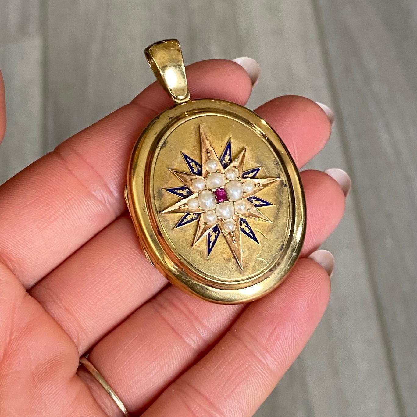 This sweet locket has a raised gold star which is set with seed pearls and has blue enamel detail and a ruby set at the centre. The back of the locket has a heart motif and a picture still at the centre. 

Locket Dimensions: 42x32mm

Weight: 18.2g

