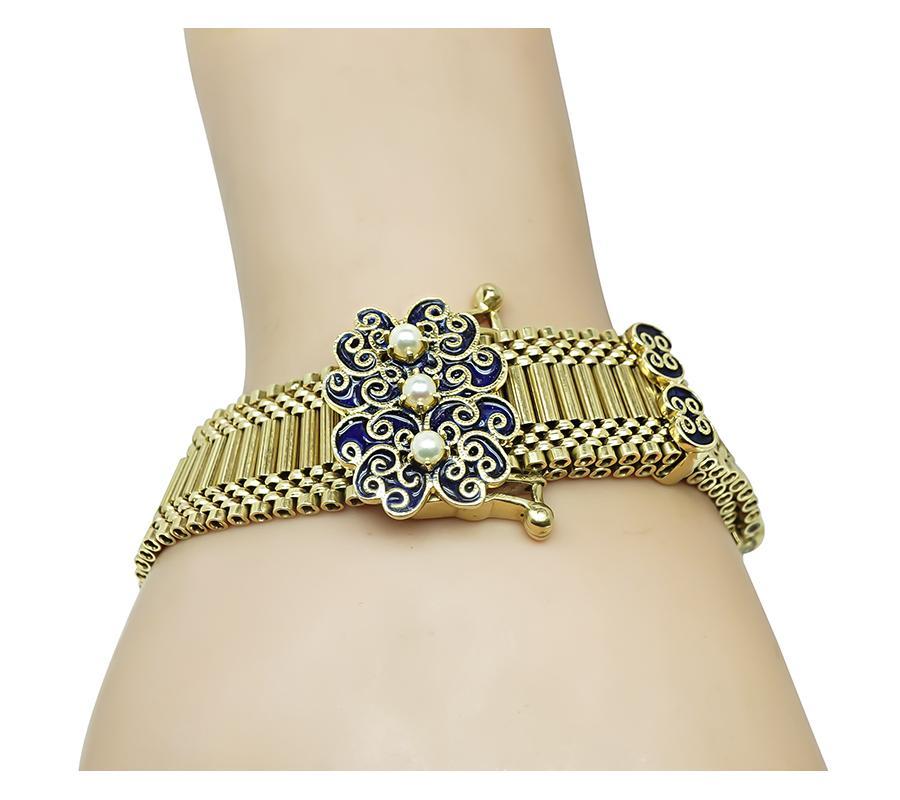 This is a fabulous 14k yellow gold enamel pearl bracelet from the Victorian era. The bracelet measures 16.5mm in width and 8 inches in length. The bracelet is stamped 14K and weighs 53.9 grams.