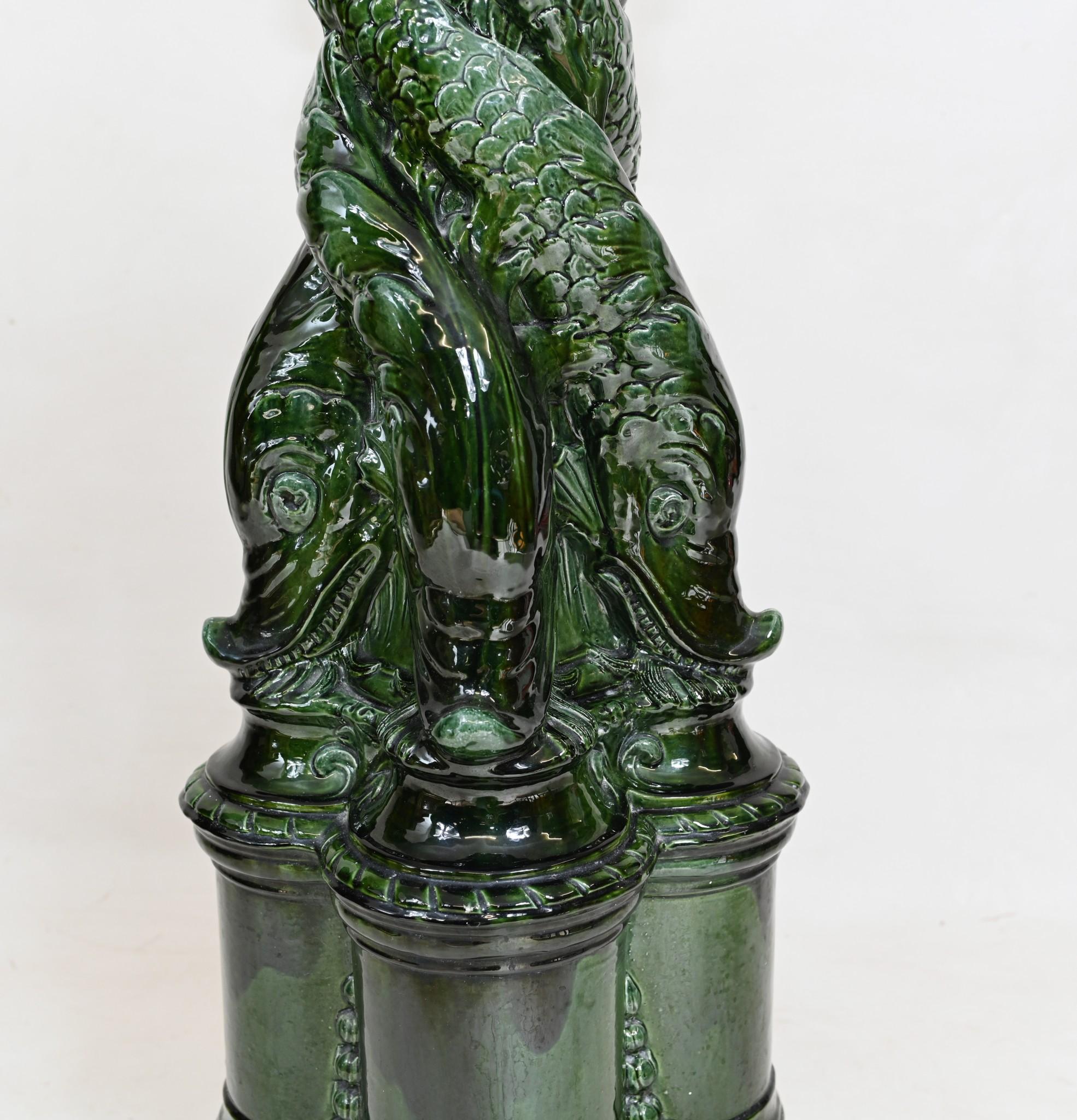 You are viewing a gorgeous Victorian enamel glazed pedestal stand
Great finish in green with the intertwined sea serpents around the central column
Great piece for displaying decorative pieces such as busts or vases 
We date this piece to circa