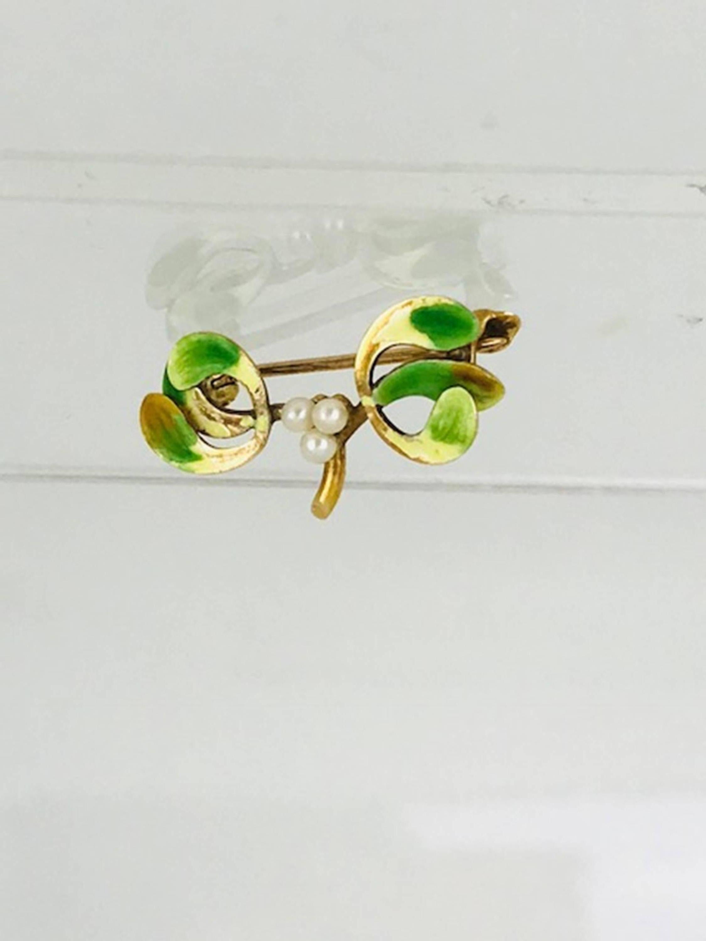 Yellow Gold based, Victorian Enamel Pin. The center consists of three matching, beautiful luster pearls 2.00 millimeters in diameter, tear-dropped in shape. 
The pin's enamel coloring is Granny Apple Color's of green. 
The pin's measurements are