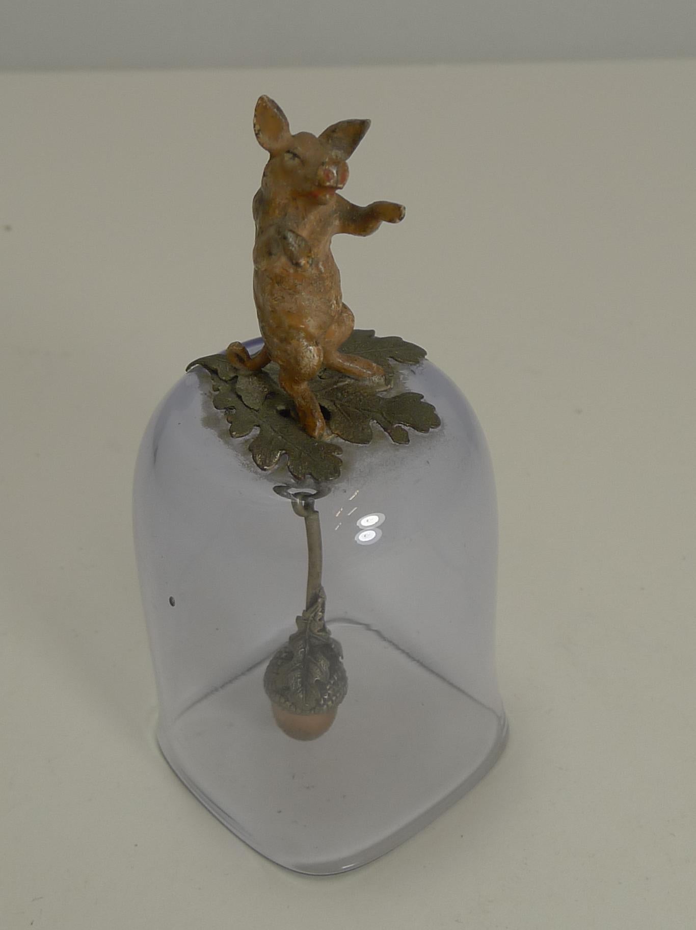 A highly collectable antique bell, a rare find and in perfect condition. The glass is a very pale amethyst color and i topped with the most charming cast cold painted bronze figure in the form of a pig standing on an Oak leaf base.

The charm