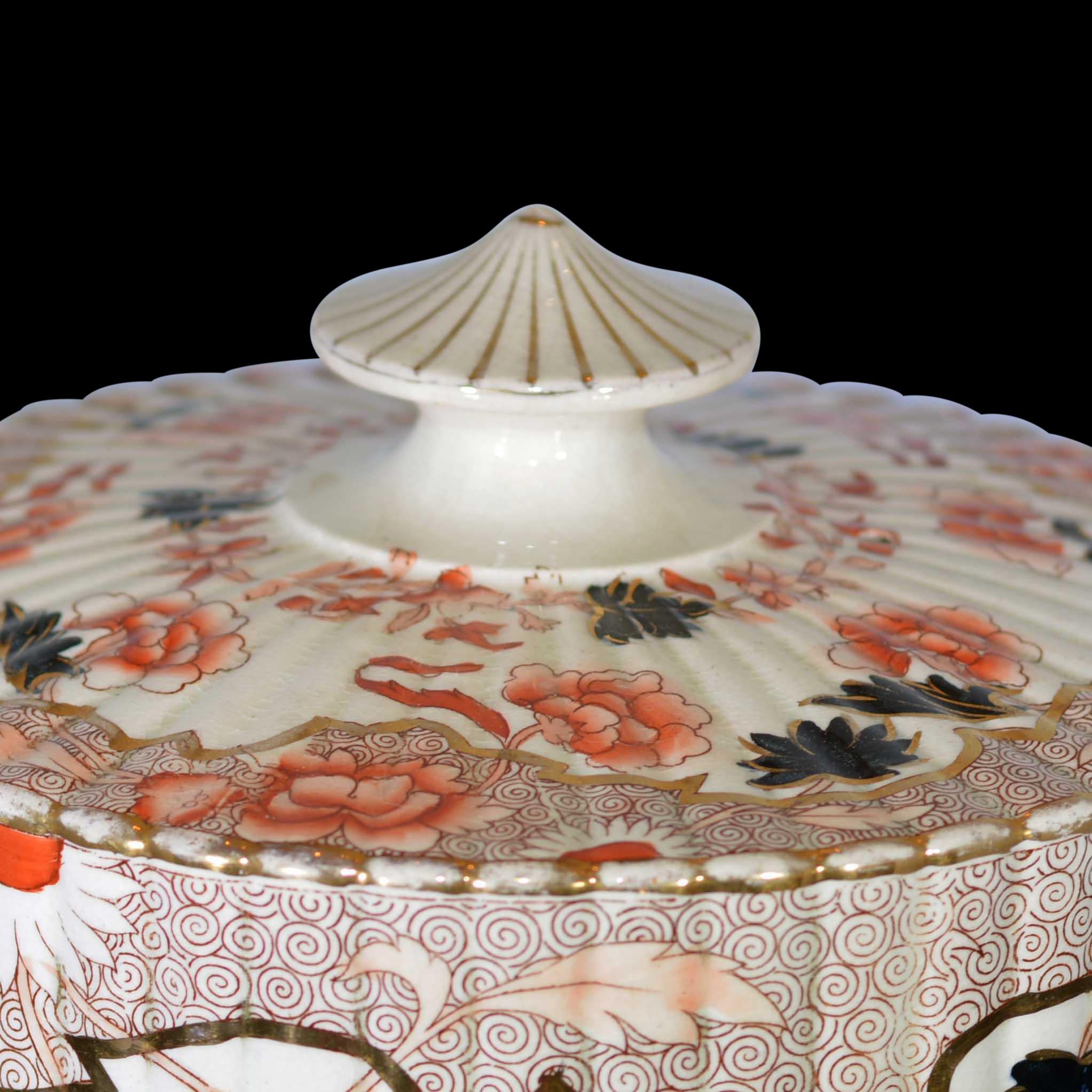 Graphic floral design in oranges, black and gold.