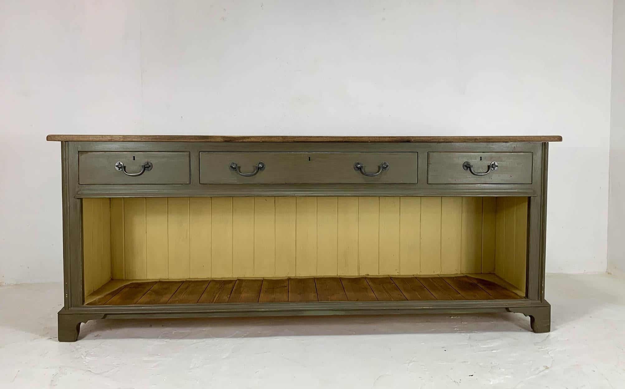 Restored English sideboard with stunning oak top. It has been recently painted in farrow and ball's ball green.
Feature three original drawers with reproduction drop handles and a potting board shelf below, great for displaying curated