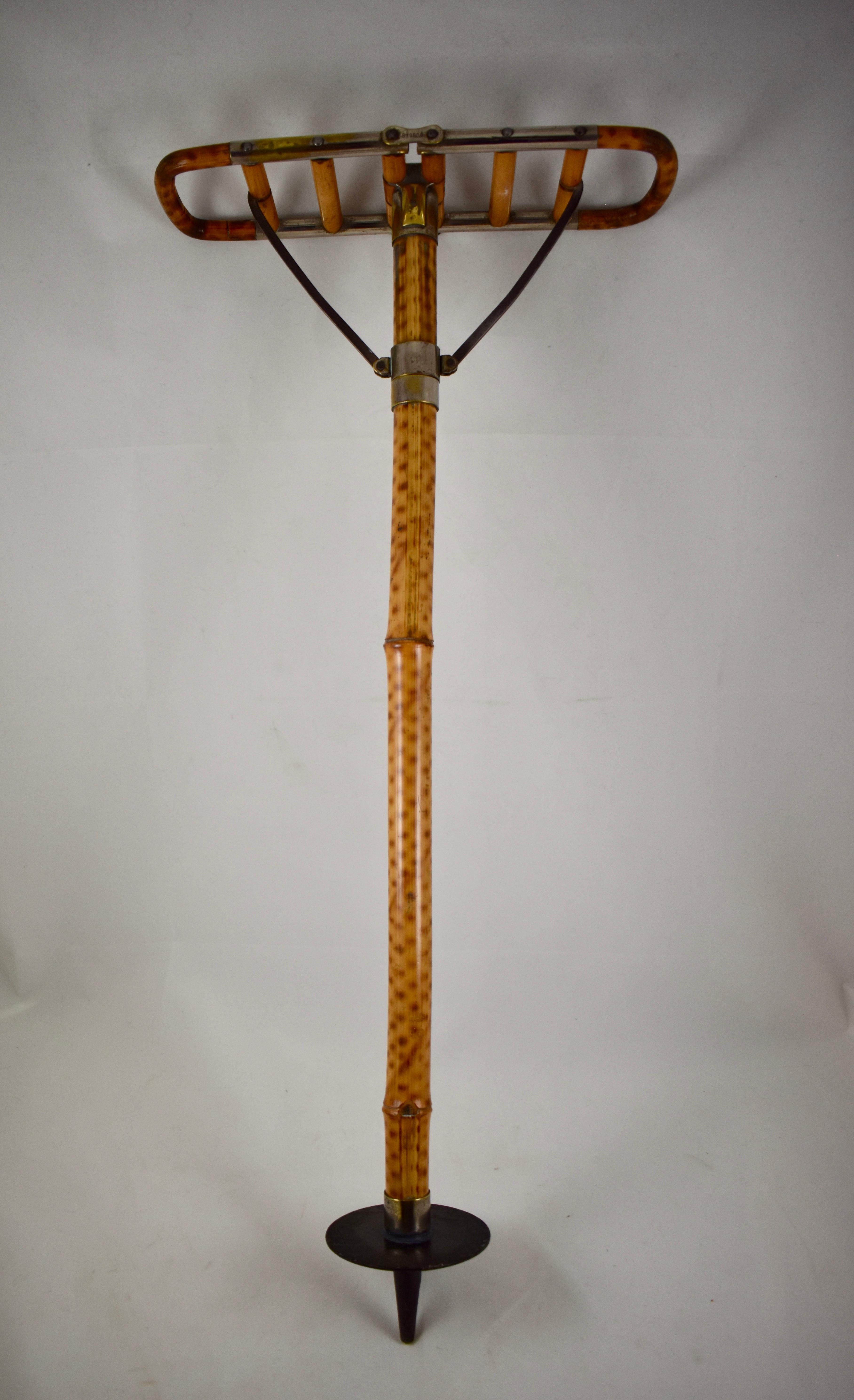 A late Victorian English gentleman’s bamboo shooting stick or sport cane. With a folding seat, circa 1880.

A good quality sports seat with brass fittings and a pointed metal disc at the bottom to support the seat in the soft ground. Made of