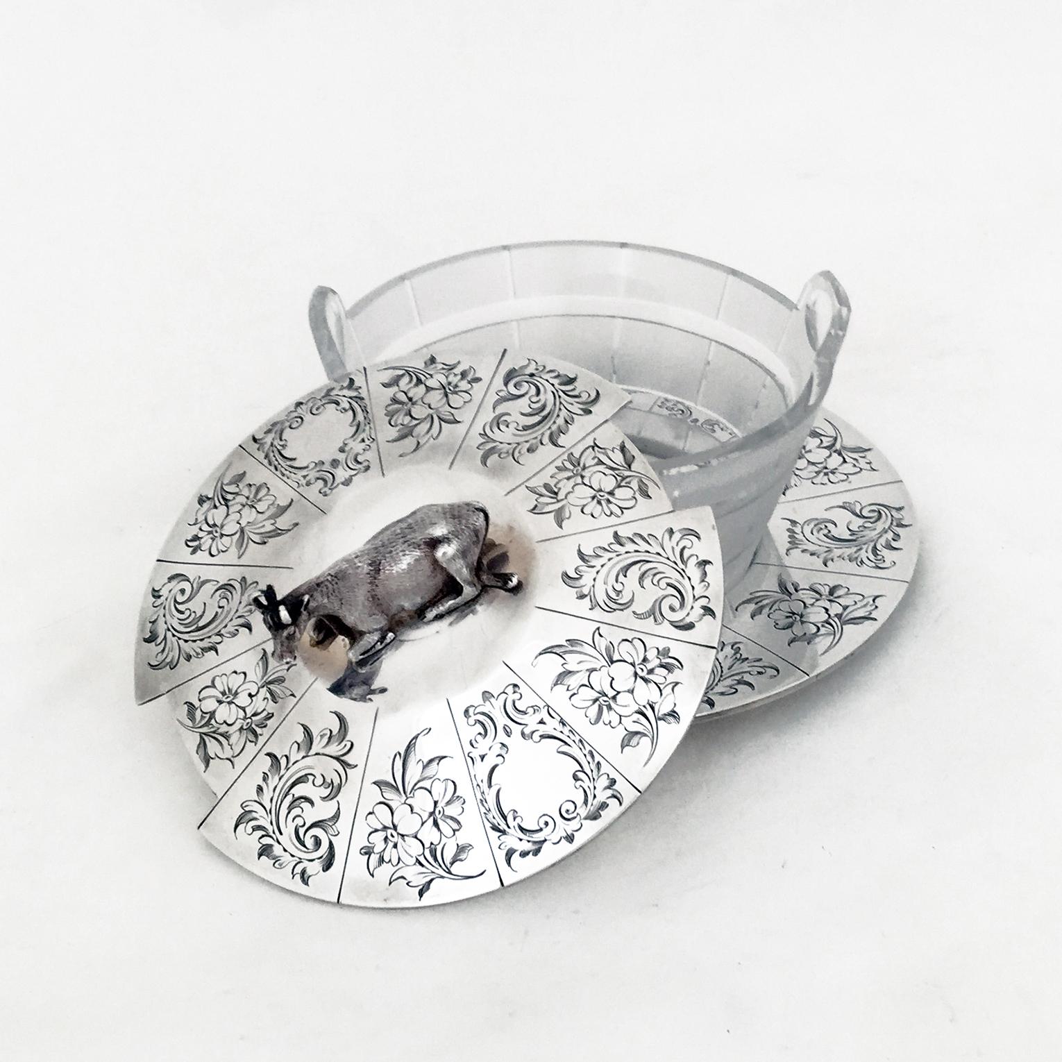 An early Victorian English silver butter dish with the original frosted glass holder.

The lid and plate of the dish have bright cut engraving - decoration typical of the period.

All the different parts- finial, screw, dish , lid - all carry