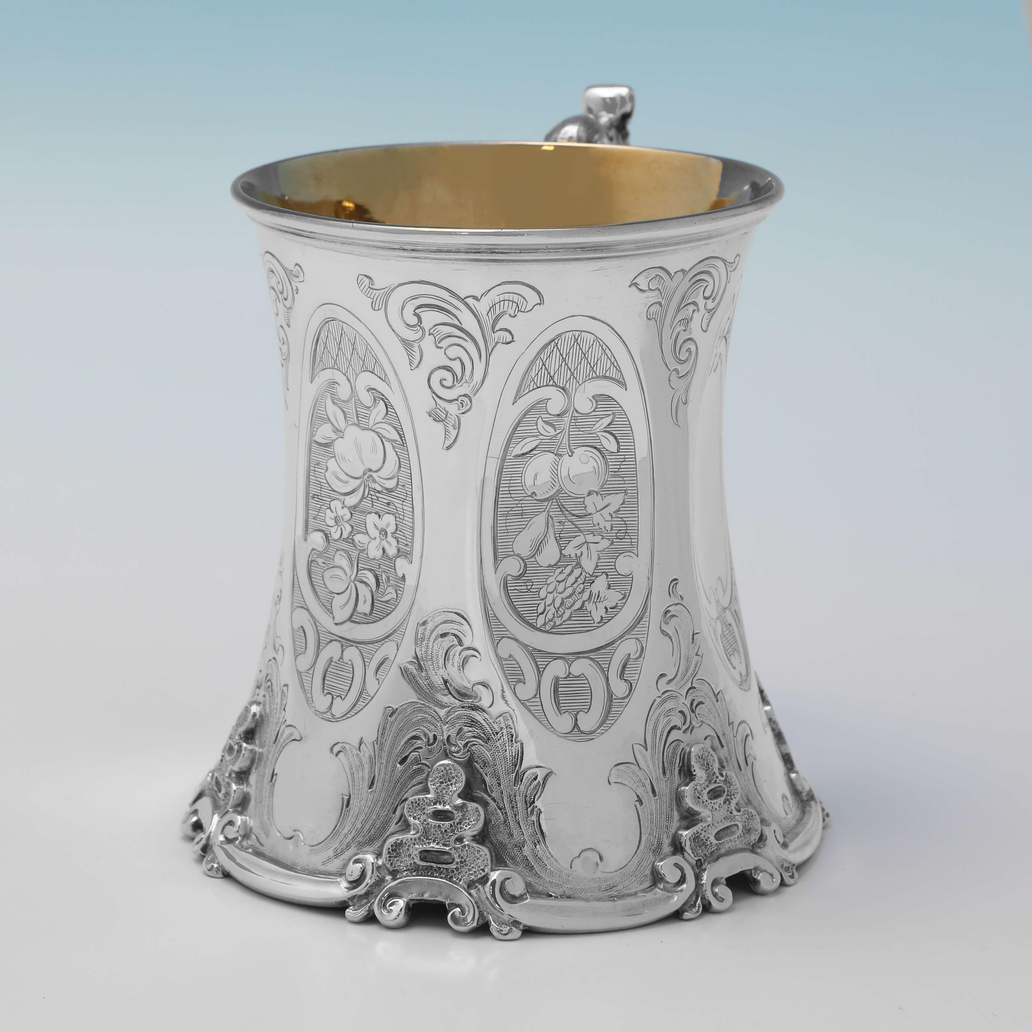 Hallmarked in London in 1853 by John Kieth, this very attractive, Victorian, Antique Sterling Silver Christening Mug, features a gilt interior, wonderful engraved decoration to the shaped body, and an ornate border around the base and handle.